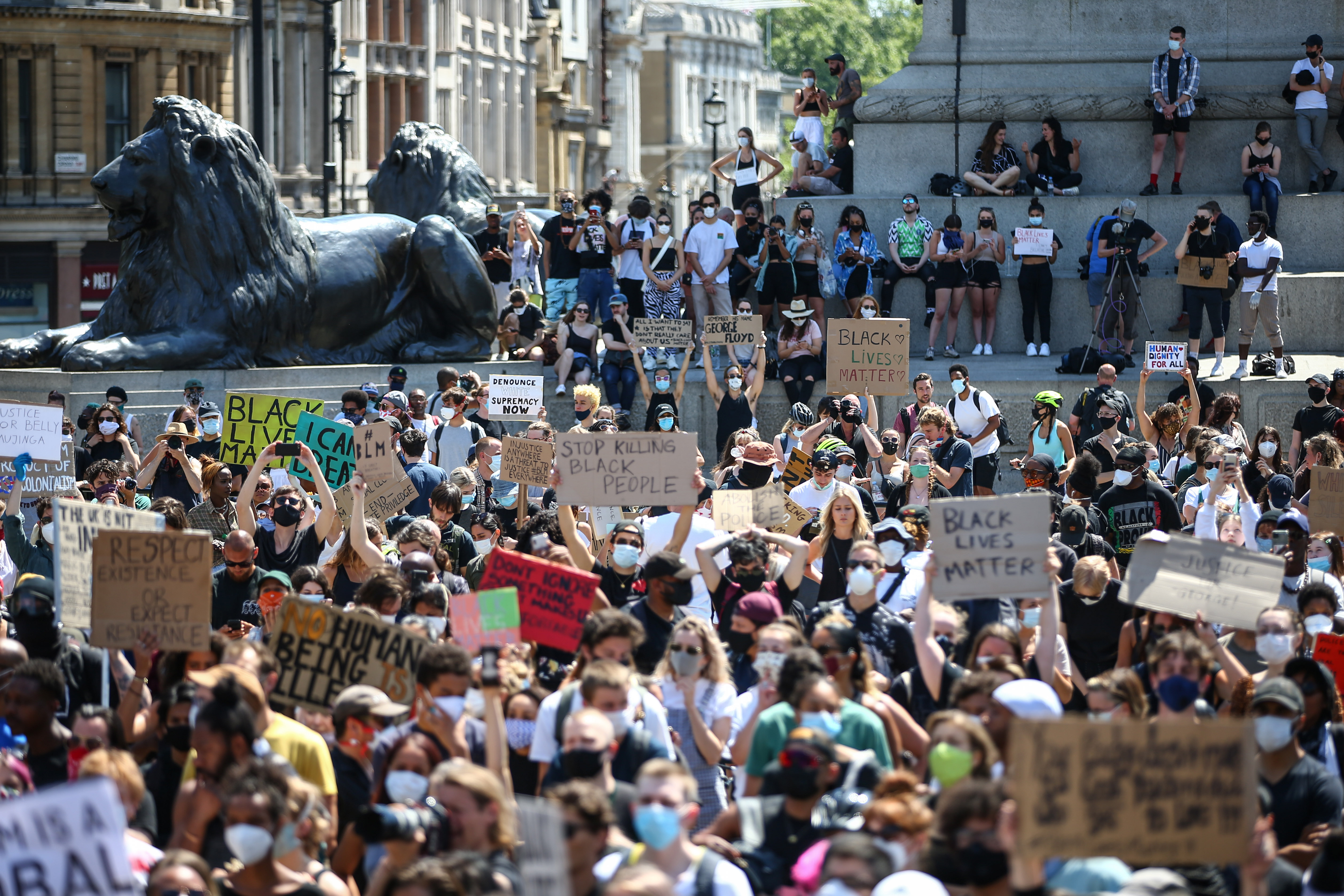 People hold placards as they join a spontaneous Black Lives Matter march at Trafalgar Square in London to protest the death of George Floyd on May 31.
