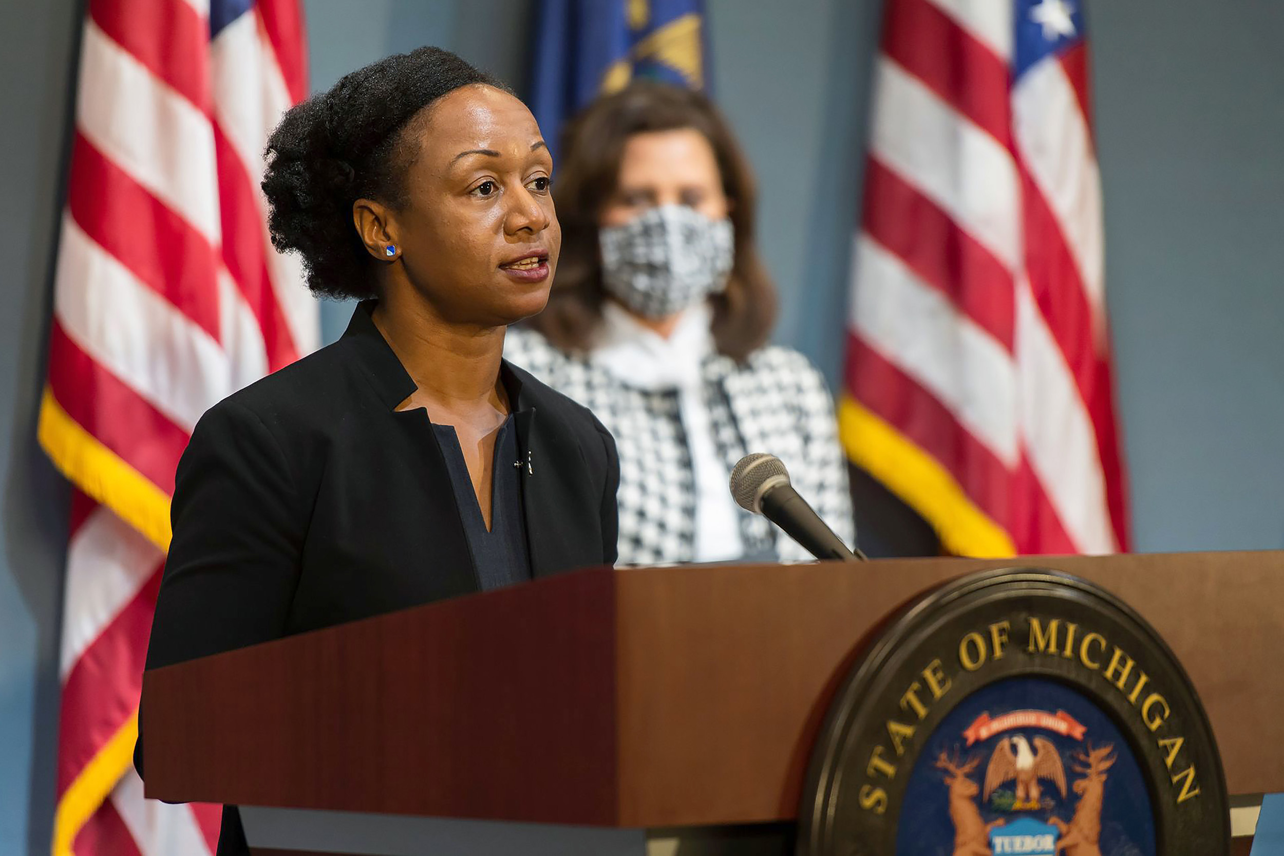 Michigan Executive Office of the Governor, Chief Medical Executive Dr. Joneigh Khaldun, left, speaks at a news conference as Gov. Gretchen Whitmer watches in Lansing, on Tuesday, May 26. 