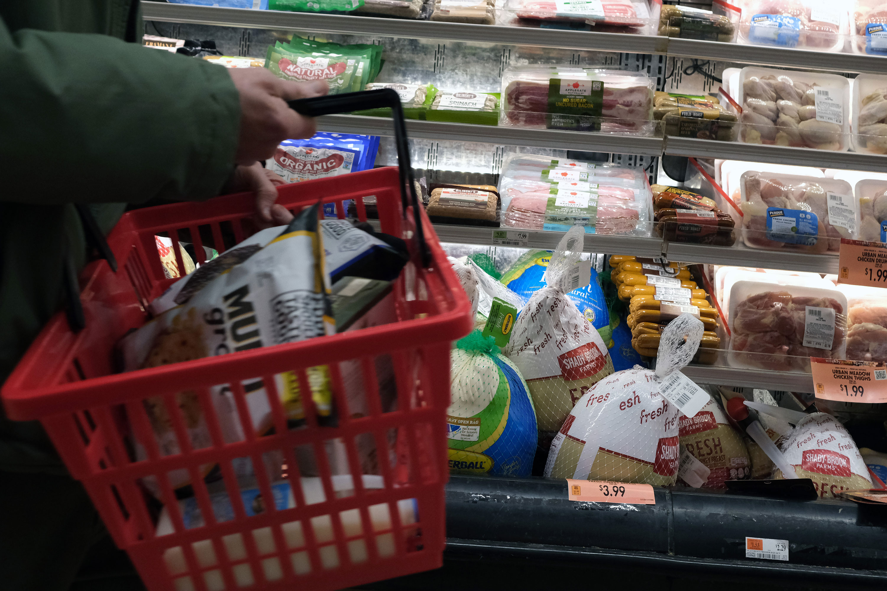 A shopper passes frozen turkeys inside a grocery store in New York on November 14.