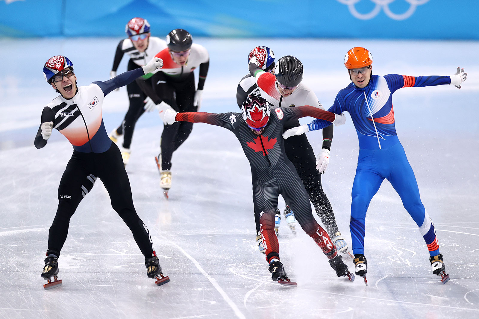 From left, South Korean speed skater Hwang Dae-heon crosses the finish line ahead of Canada's Steven Dubois and the ROC's Semen Elistratov to win the men's 1,500m short track final on February 9.
