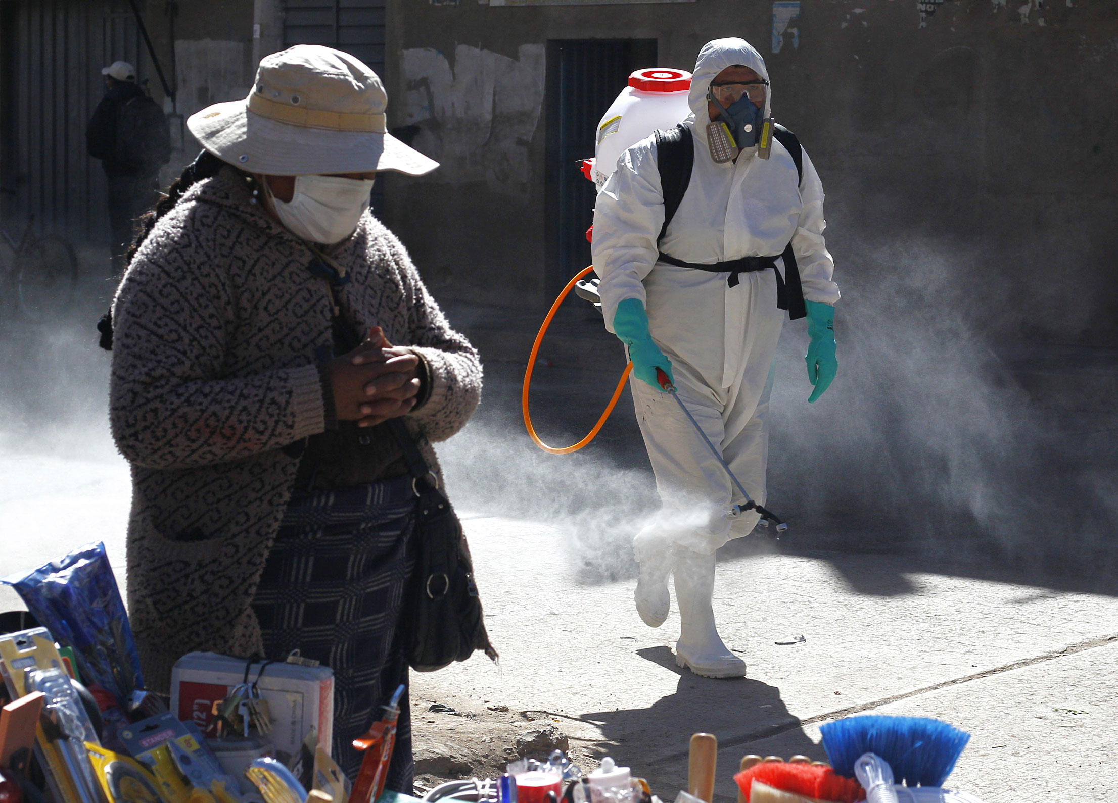 A municipal worker sprays disinfectant at a market on June 10 in Puno, Peru.