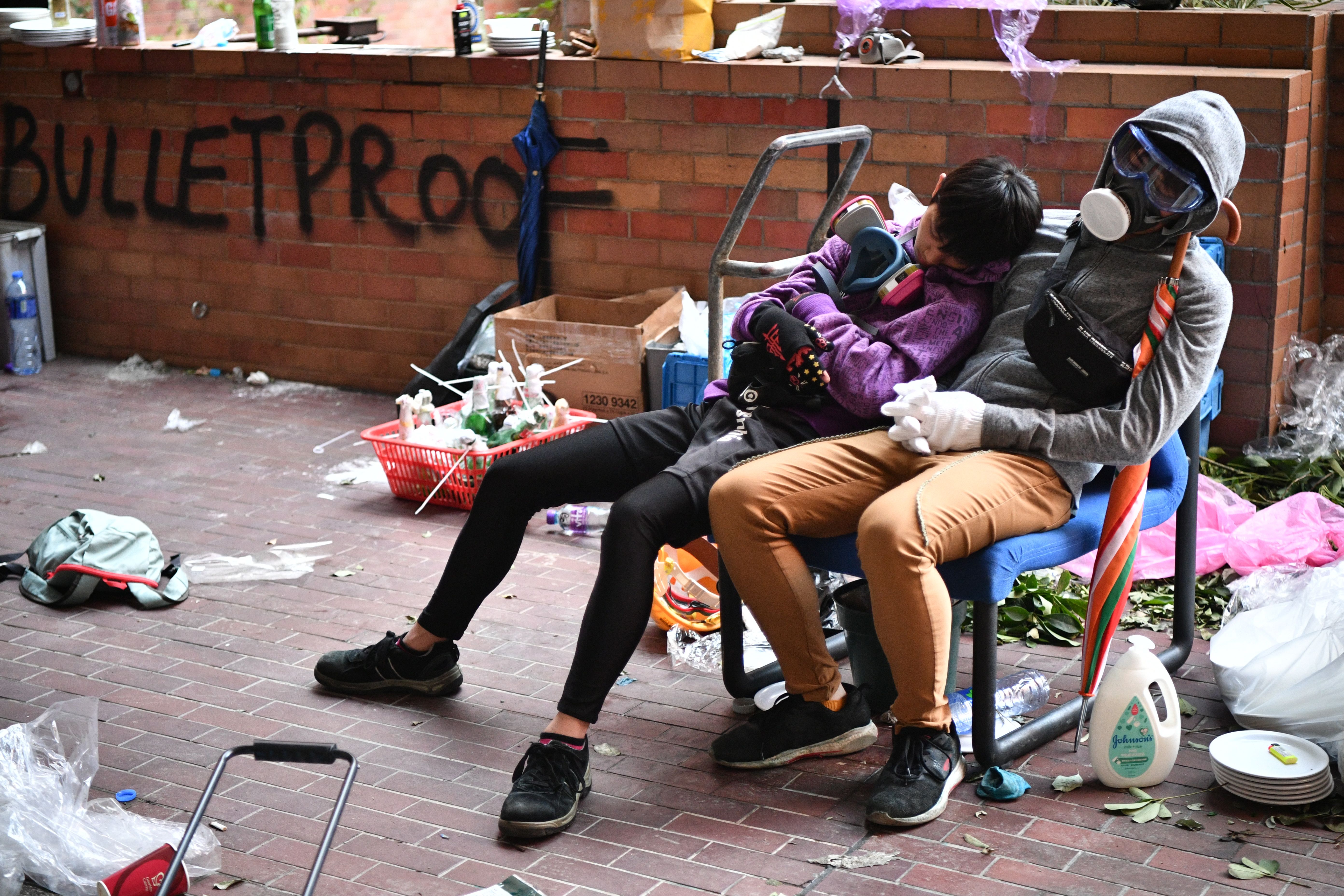Protesters rest during a lull in clashes at the Hong Kong Polytechnic University in Hung Hom district of Hong Kong on November 18.