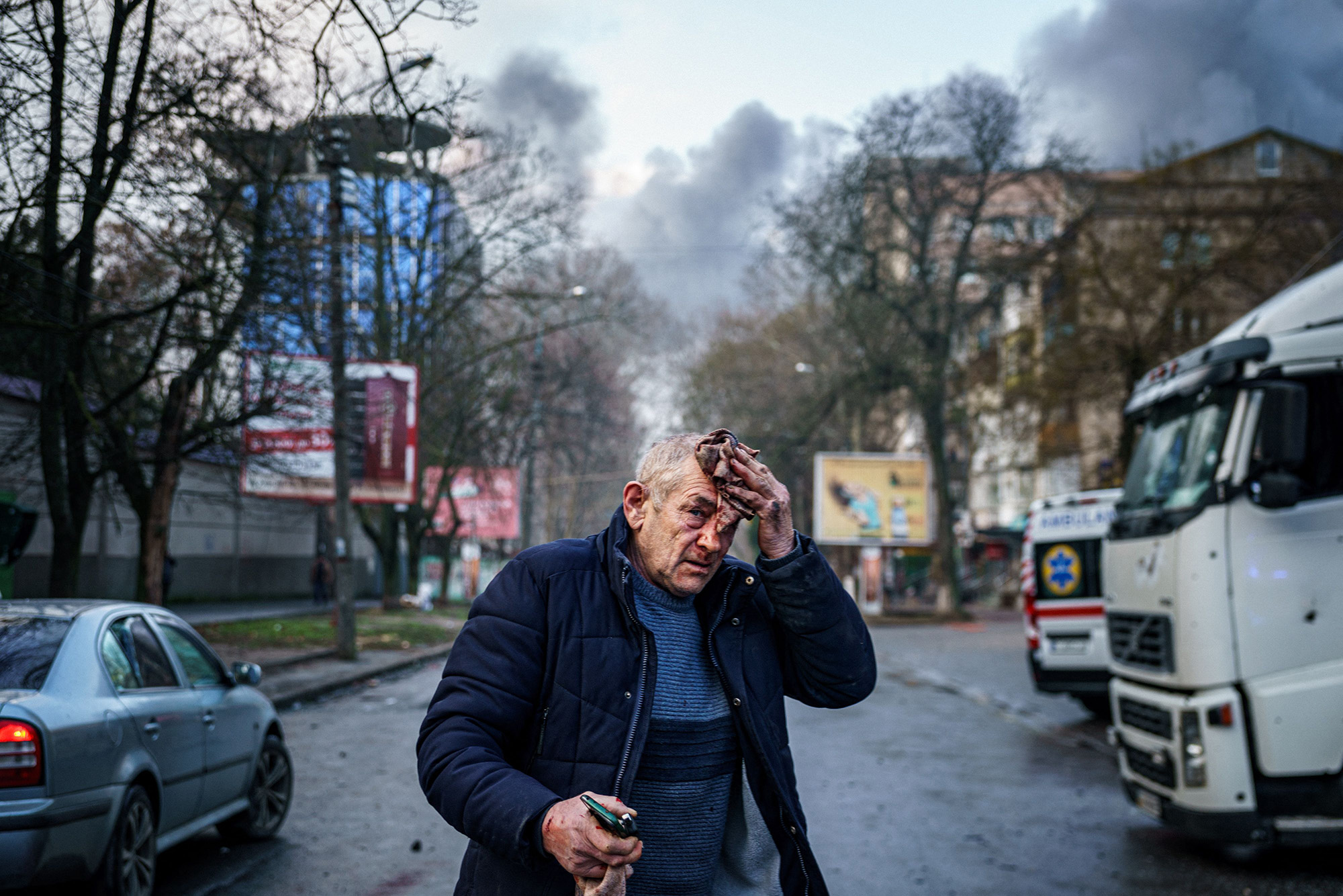 An injured man stands in the street after Russian shelling in the city of Kherson, Ukraine, on December 24.