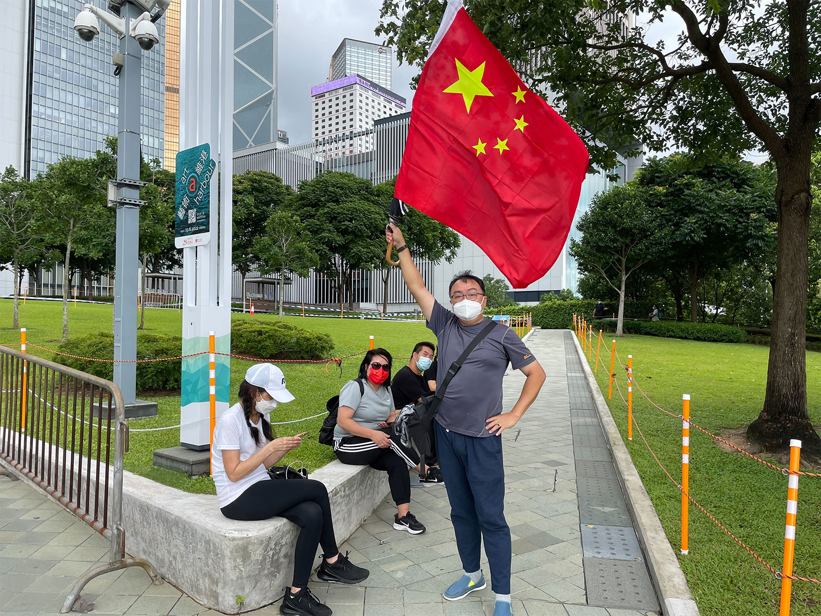 Paul Choi waves the national flag of China, hopeful the new administration would bring stability to Hong Kong as the city marked its 25th year of Chinese rule on July 1.