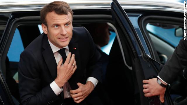 France's President Emmanuel Macron gets out of his car as he arrives at the EU leaders summit. 