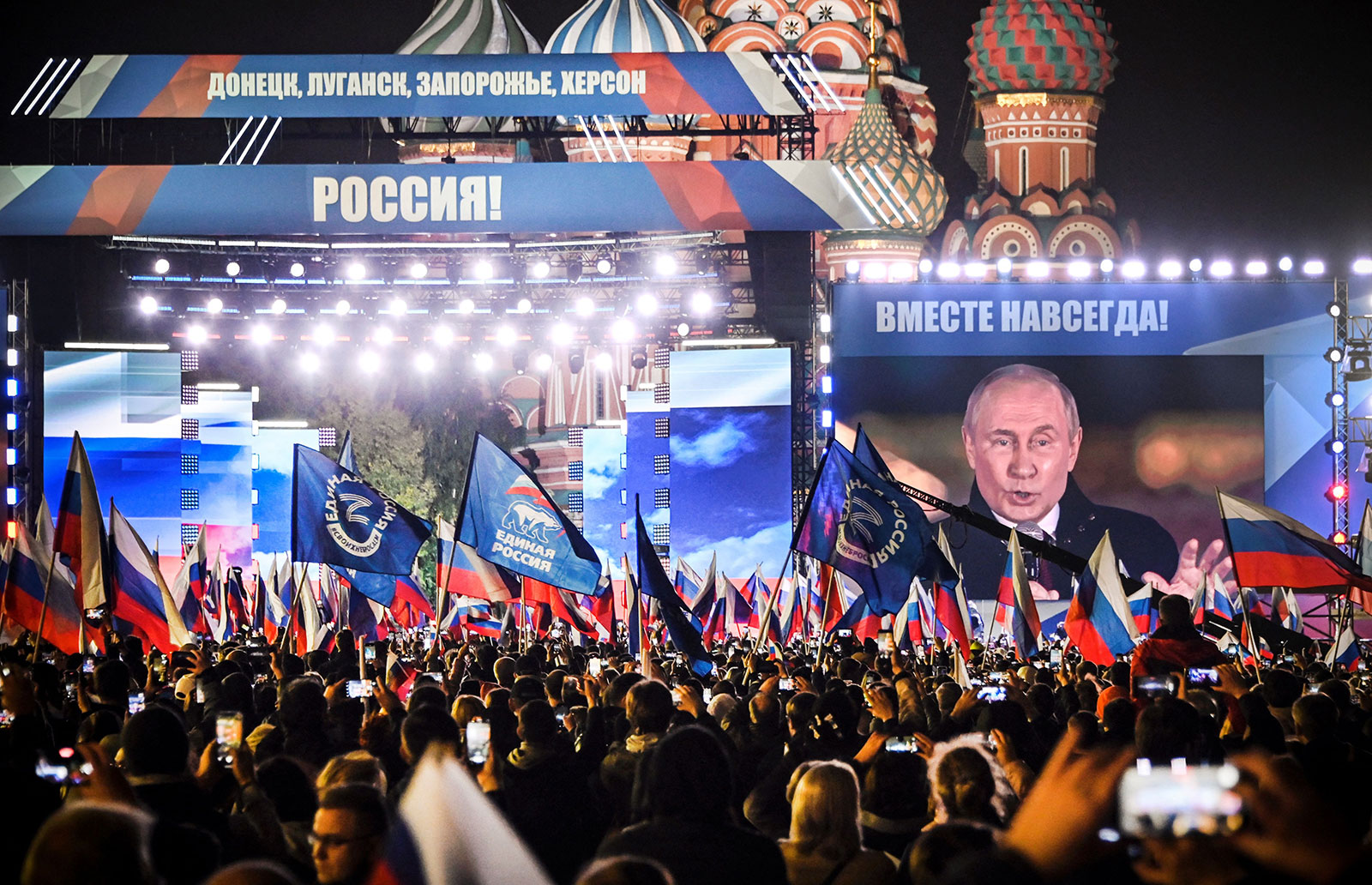Russian President Vladimir Putin is seen on a screen set at Red Square in Moscow on Friday.