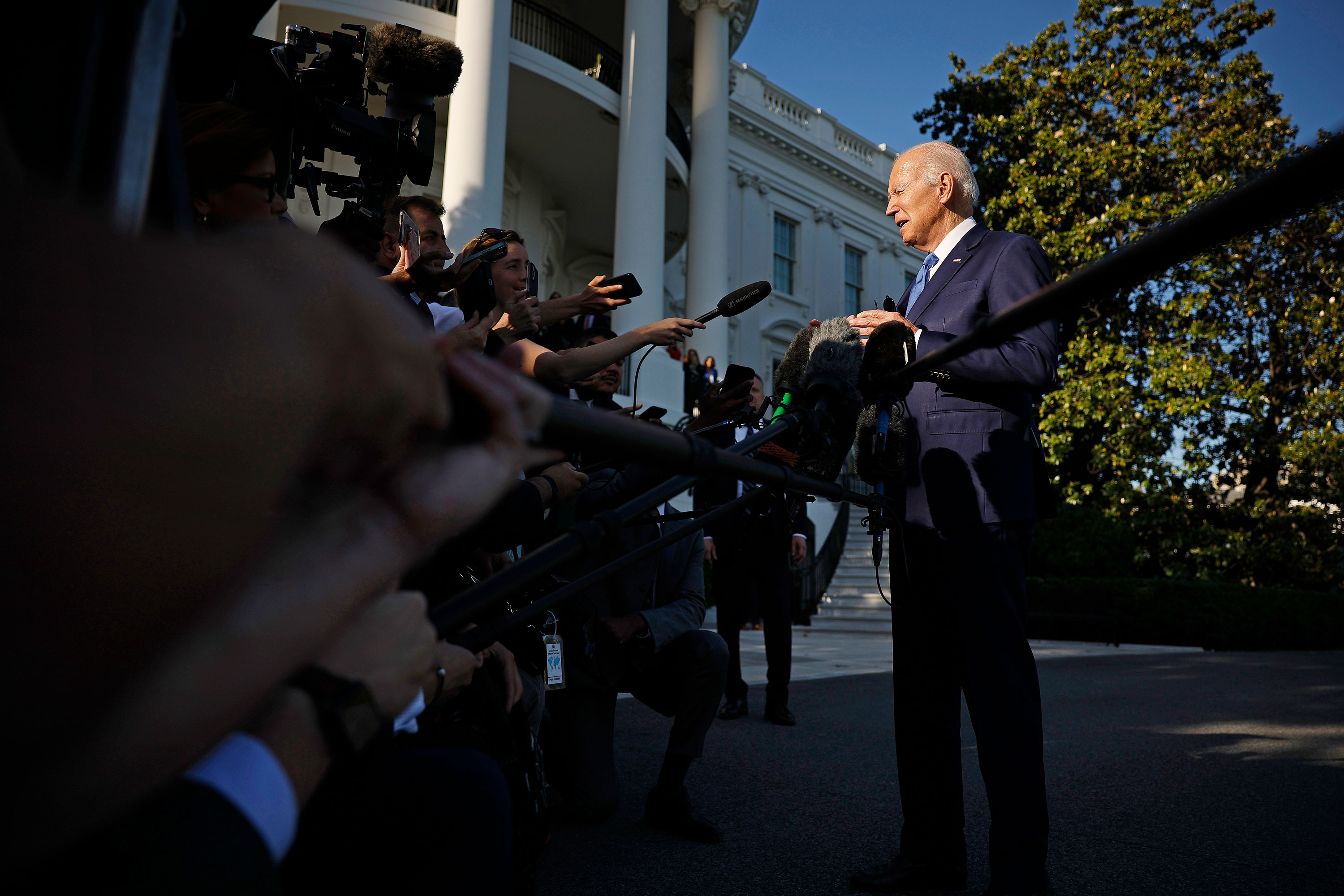 President Joe Biden talks to reporters as he departs the White House on May 26. 