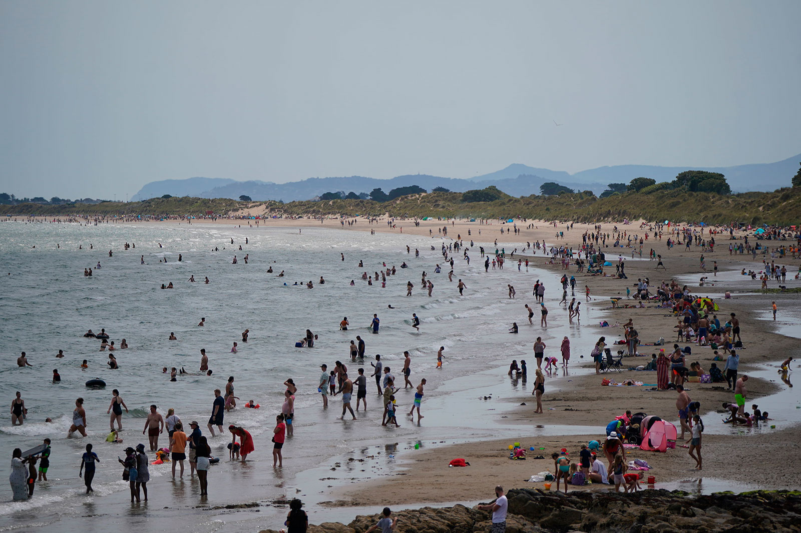 Beachgoers gather at Portmarnock beach near Dublin, Ireland, on Monday.