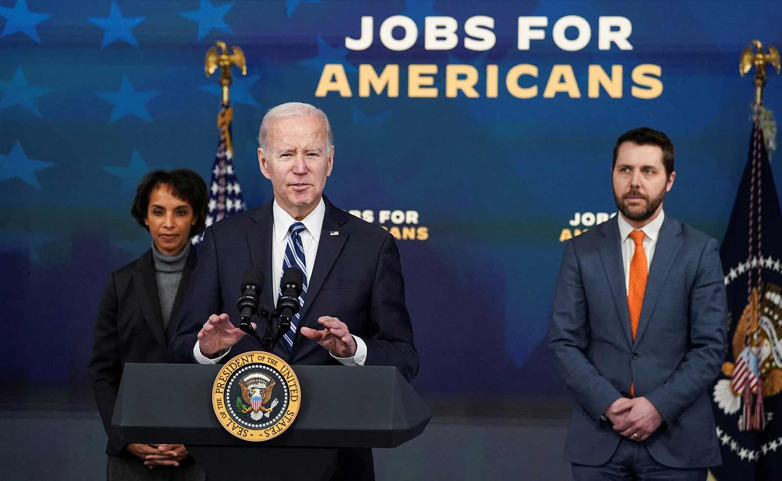 U.S. President Joe Biden is flanked by National Economic Council Director Brian Deese and White House Council of Economic Advisers Chair Cecilia Rouse as he speaks about the economy and the January jobs report at the White House today. 