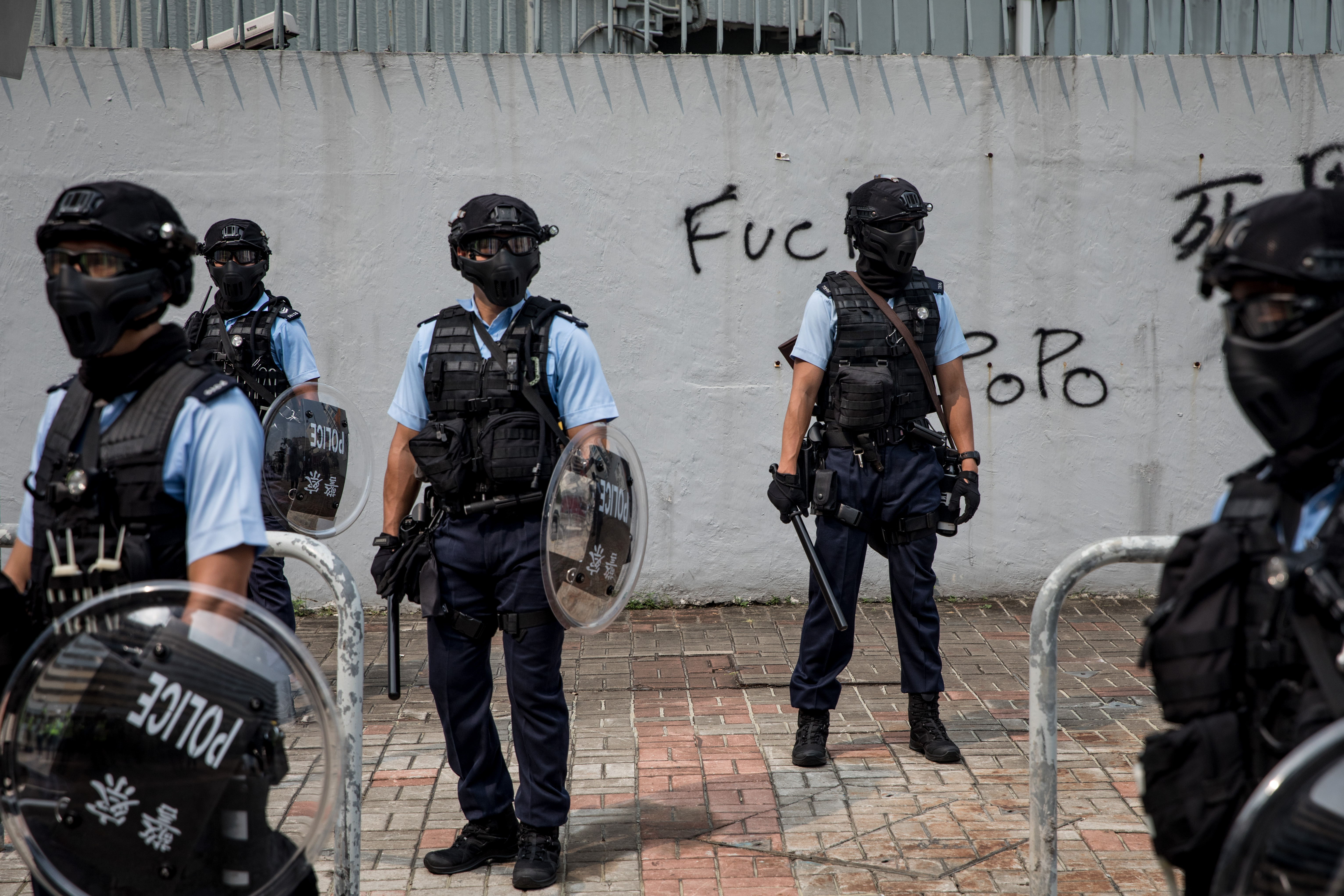 Police stand guard in front of a police station on August 24, 2019 in Hong Kong.