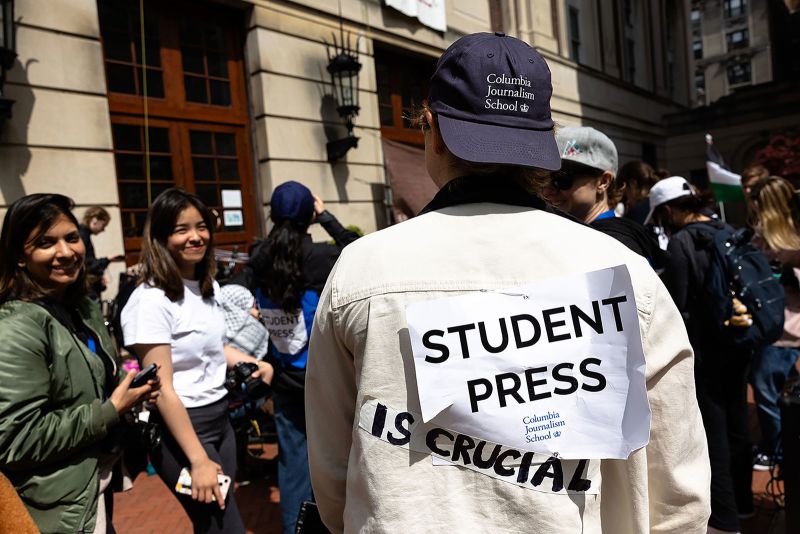 A Columbia Journalism student journalist shows off their sign as they cover the events at Hamilton Hall at Columbia University on Tuesday, April 30.