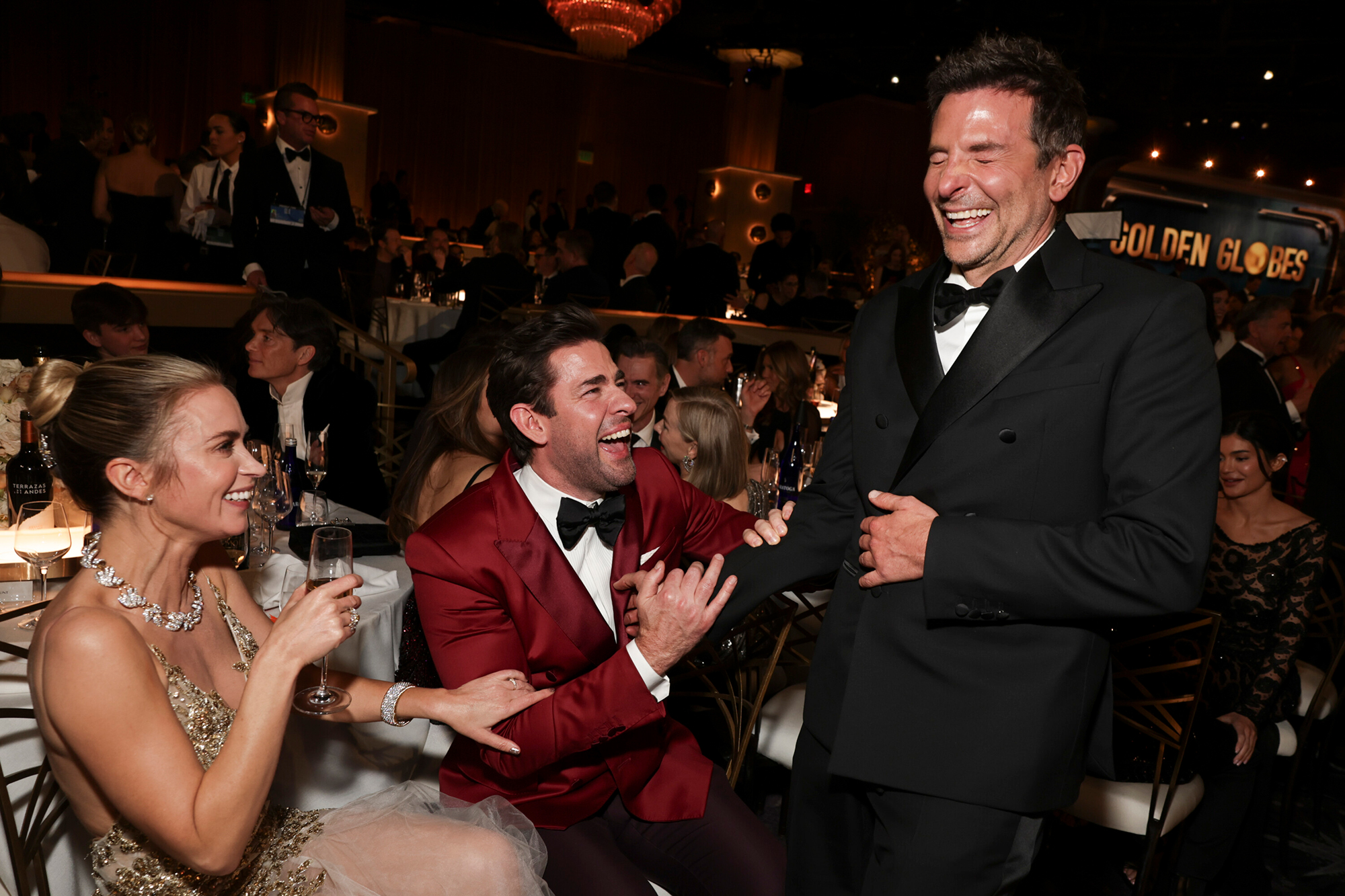 Bradley Cooper laughs with John Krasinski and Emily Blunt.