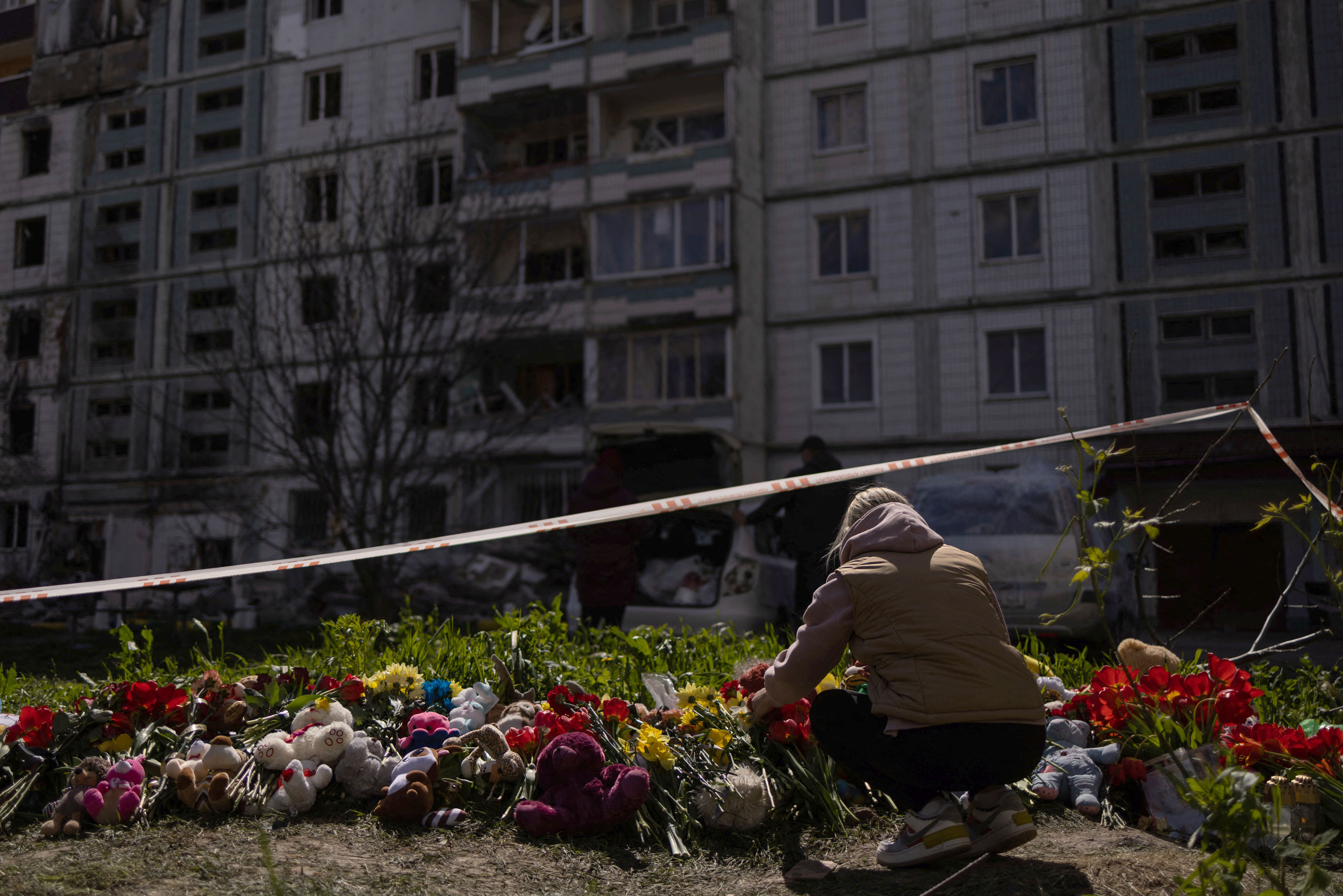 A woman pays tribute to civilians killed by a Russian missile strike in Uman, Ukraine, on April 29. 