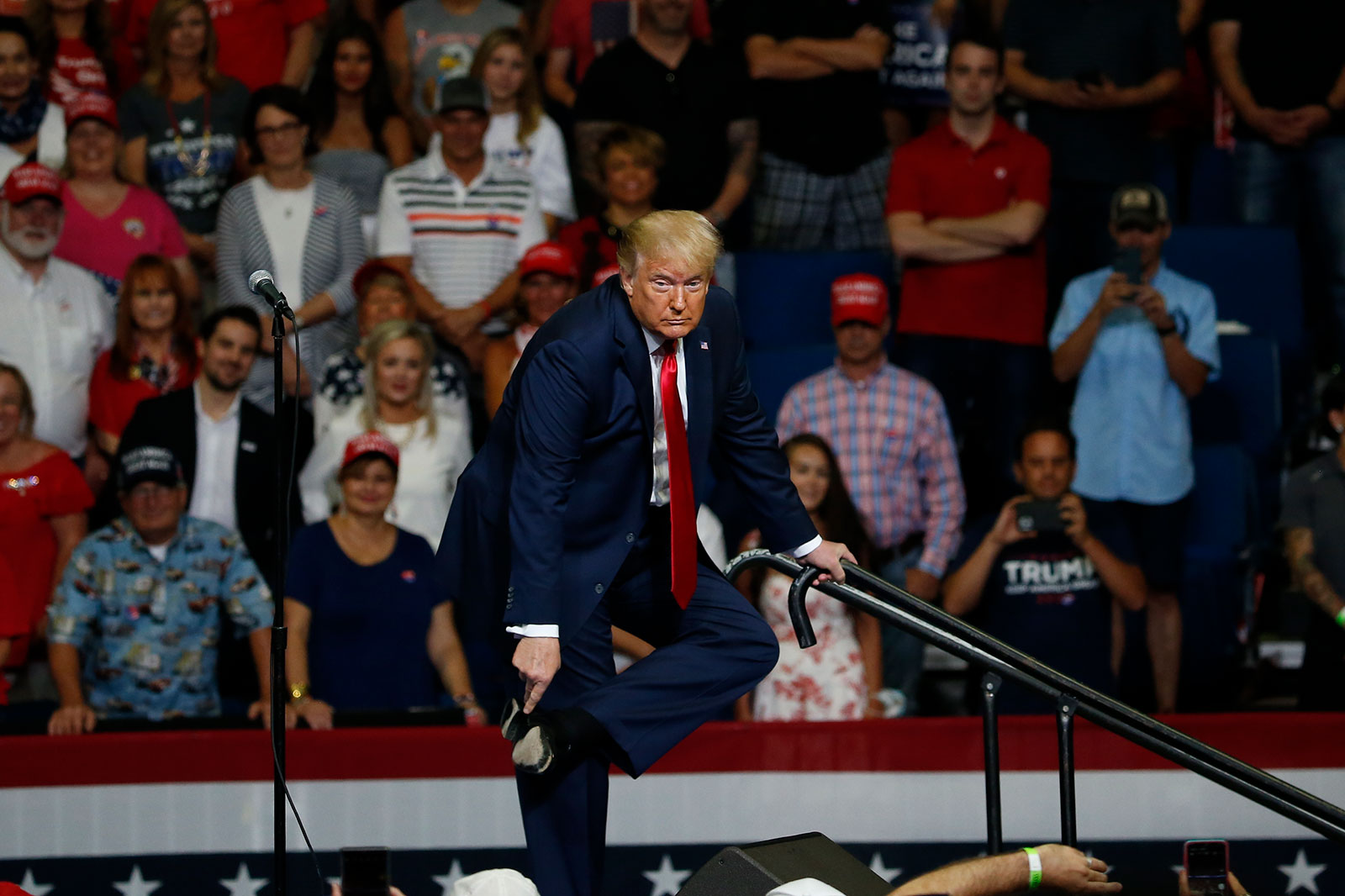 President Trump points to his shoe while speaking about the slippery ramp at West Point.