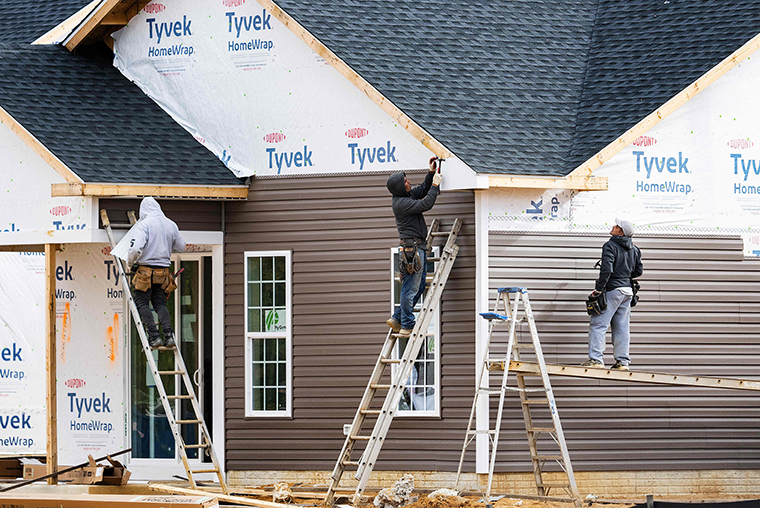 Workers at a new home construction site in Trappe, Maryland, on October 28, 2022.