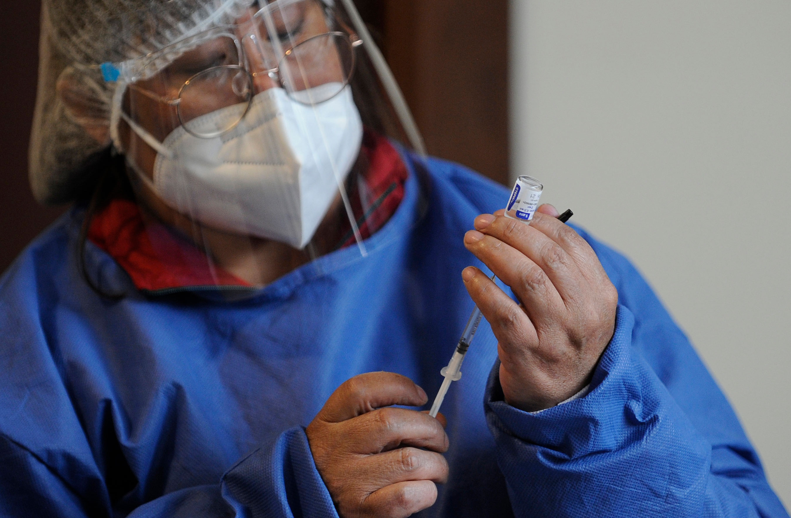 A health worker prepares to administer a dose of Russia's Sputnik V vaccine at the Cotahuma Hospital in La Paz, Bolivia, on February 3.