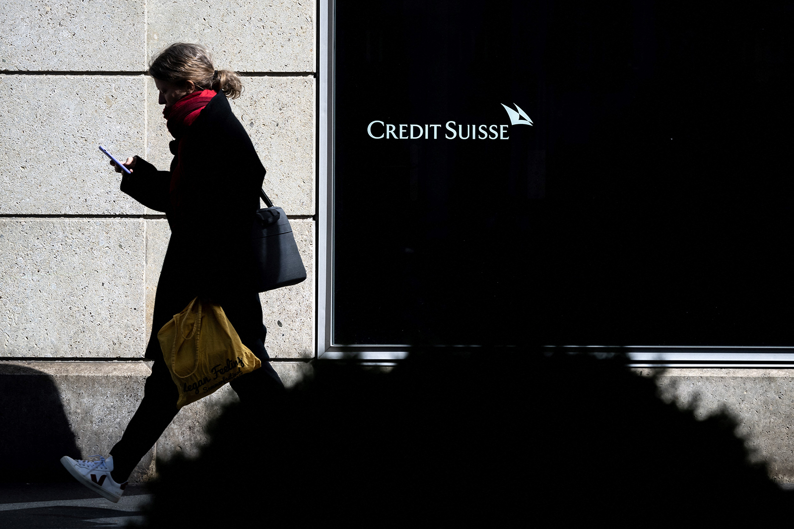 A woman walks past a branch of Switzerland's Credit Suisse bank in Vevey, western Switzerland, on March 15.