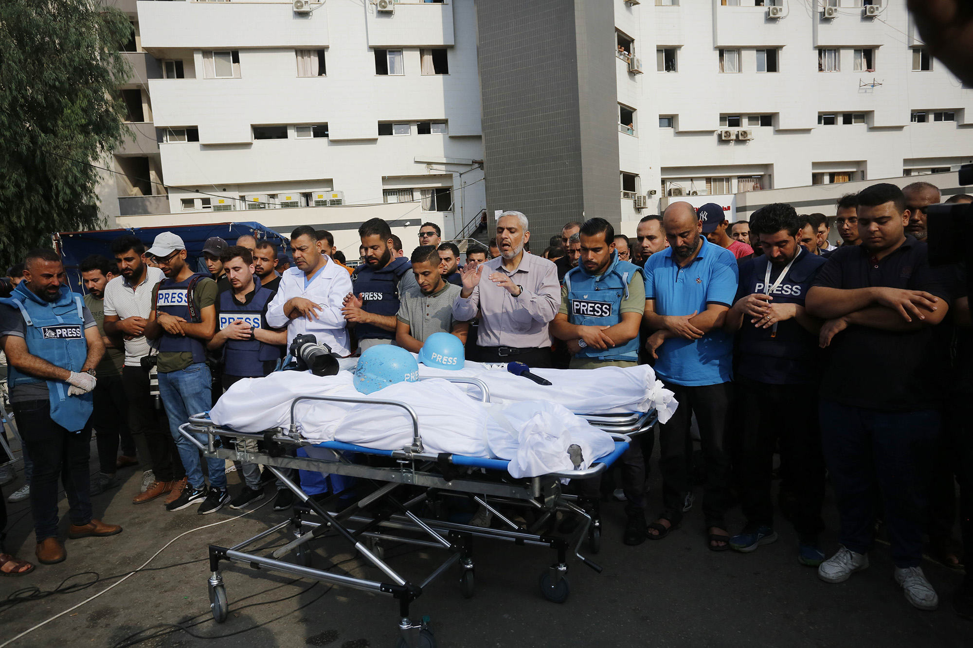Relatives and colleagues of Palestinian journalists Saeed Al-Taweel and Mohammad Sobh, who were killed in Israeli airstrikes, perform funeral prayer in Gaza on October 10.