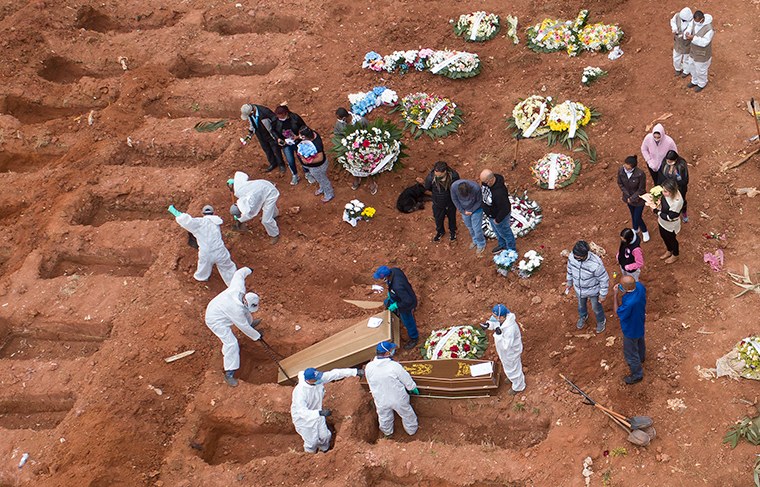 Cemetery workers in protective clothing bury victims of the new coronavirus at the Vila Formosa cemetery in Sao Paulo, Brazil, Wednesday, July 15.