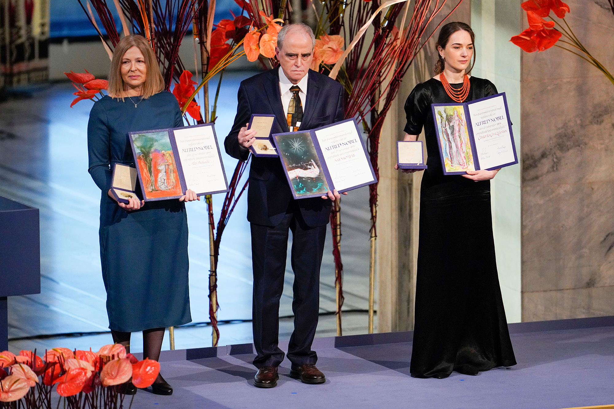 Les lauréats du prix Nobel de la paix Natallia Pintsyuk, à gauche, représentant son mari, l'activiste Ales Bialiatski, Yan Rachinsky, représentant l'organisation russe Memorial et Oleksandra Matviichuk, représentant l'organisation ukrainienne Centre pour les libertés civiles, posent avec leurs prix lors d'une cérémonie à Oslo, en 2022. 