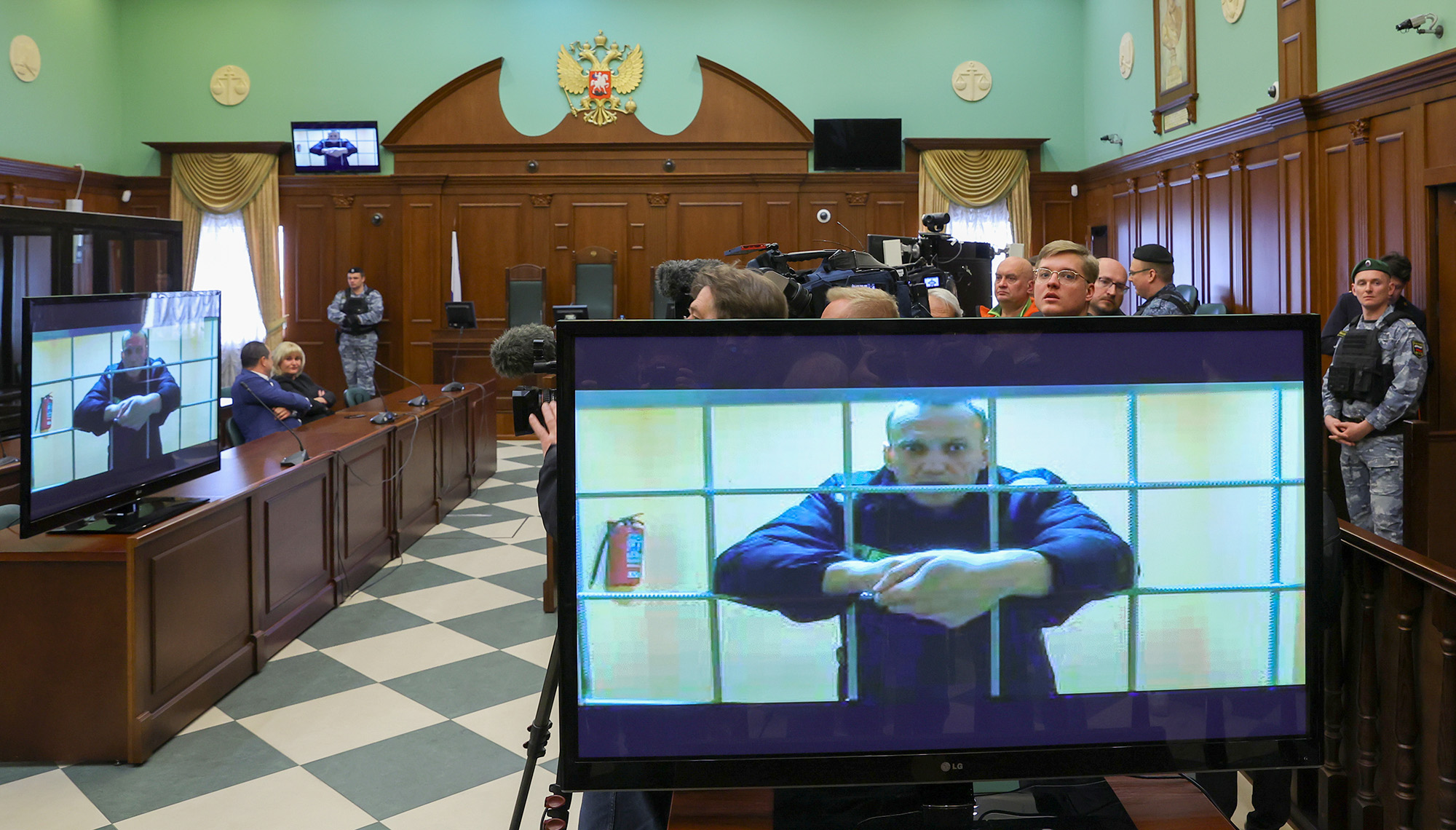 Russian opposition leader Alexei Navalny is seen on screens via a video link from the IK-2 corrective penal colony in Pokrov during a court hearing to consider an appeal against his prison sentence in Moscow, Russia, on May 24, 2022.