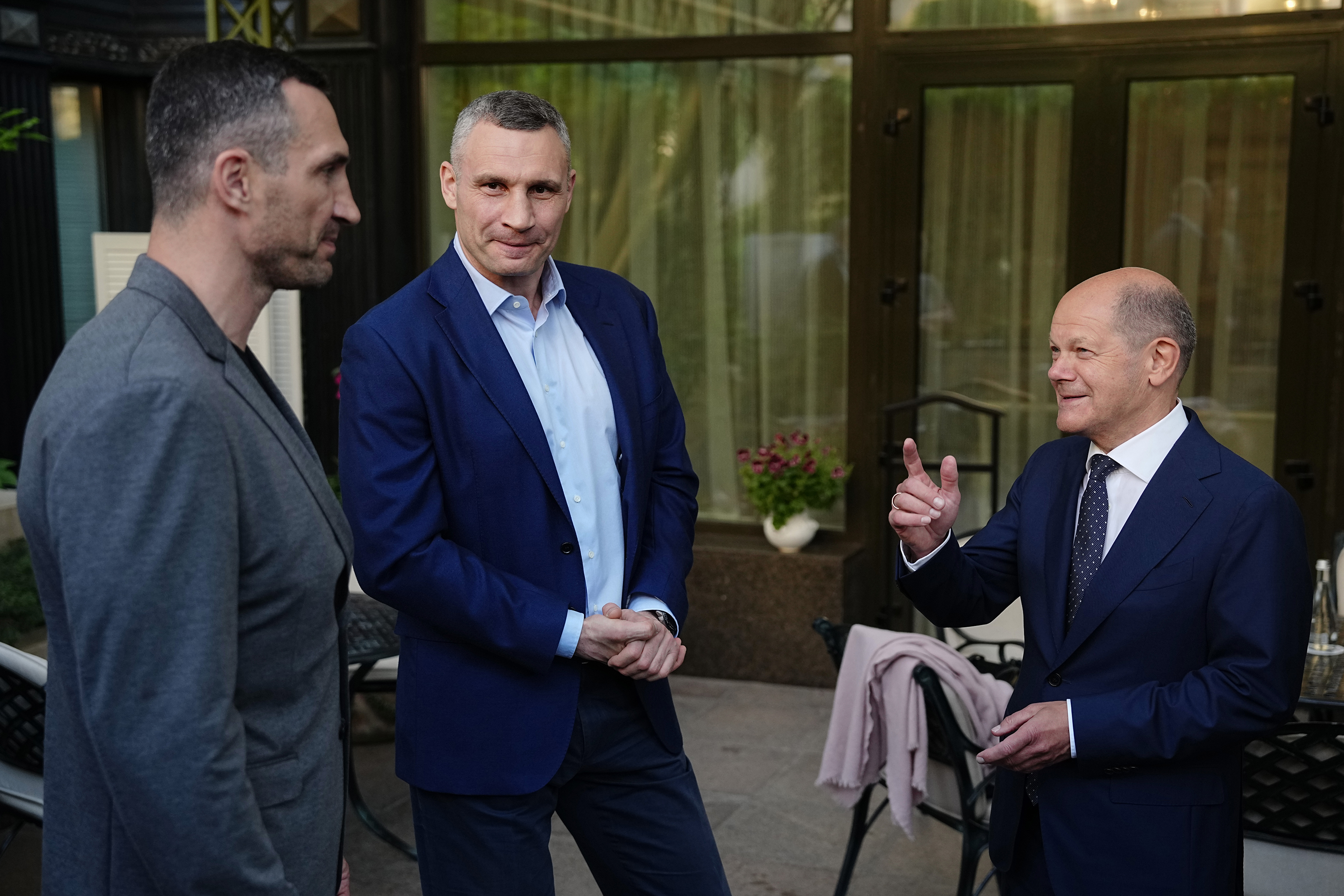 Kyiv Mayor Vitali Klitschko (M) and his brother Vladimir Klitschko (L) talk with German Chancellor Olaf Scholz on Thursday in Kyiv, Ukraine.