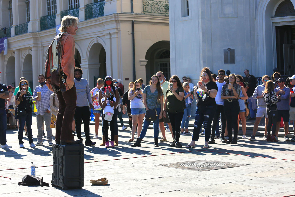 A street artist performs at New Orleans' French Quarter on Saturday, October 17, when the city eased restrictions on bars and restaurants.