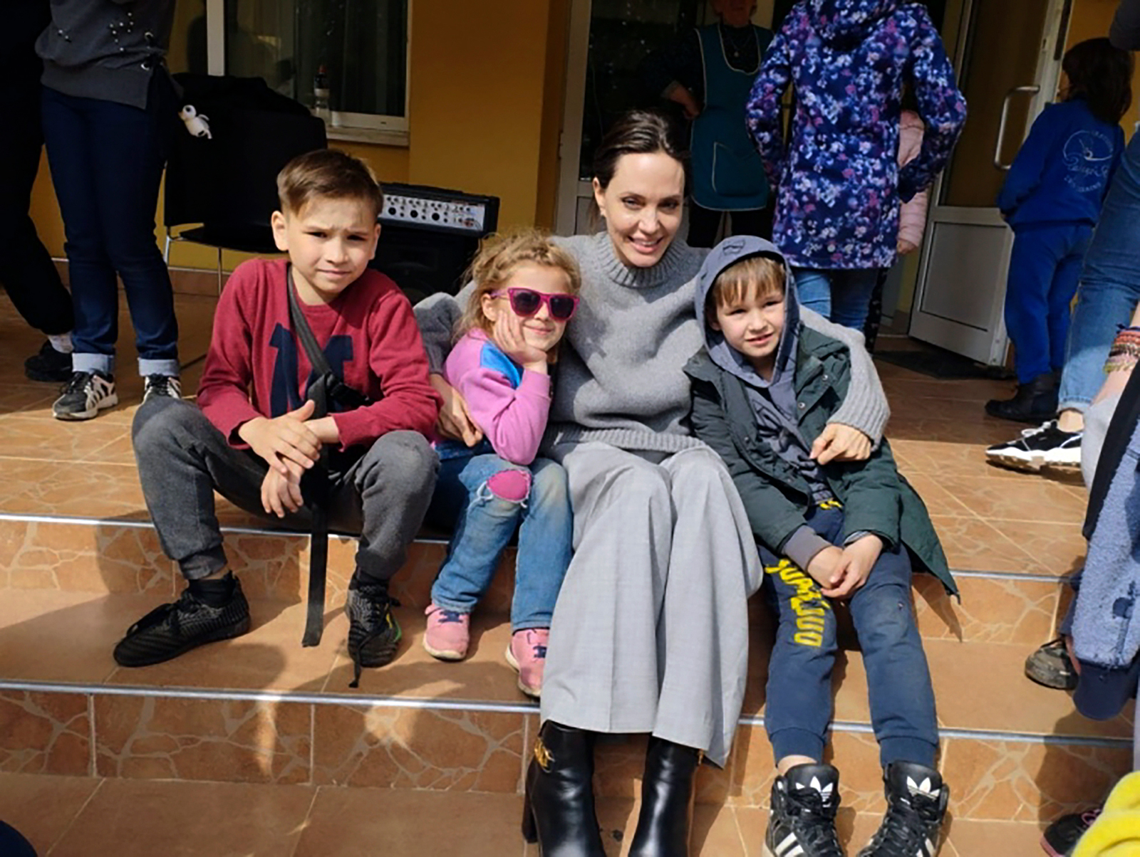 Angelina Jolie poses for photo with kids in Lviv, Ukraine, on Saturday, April 30.