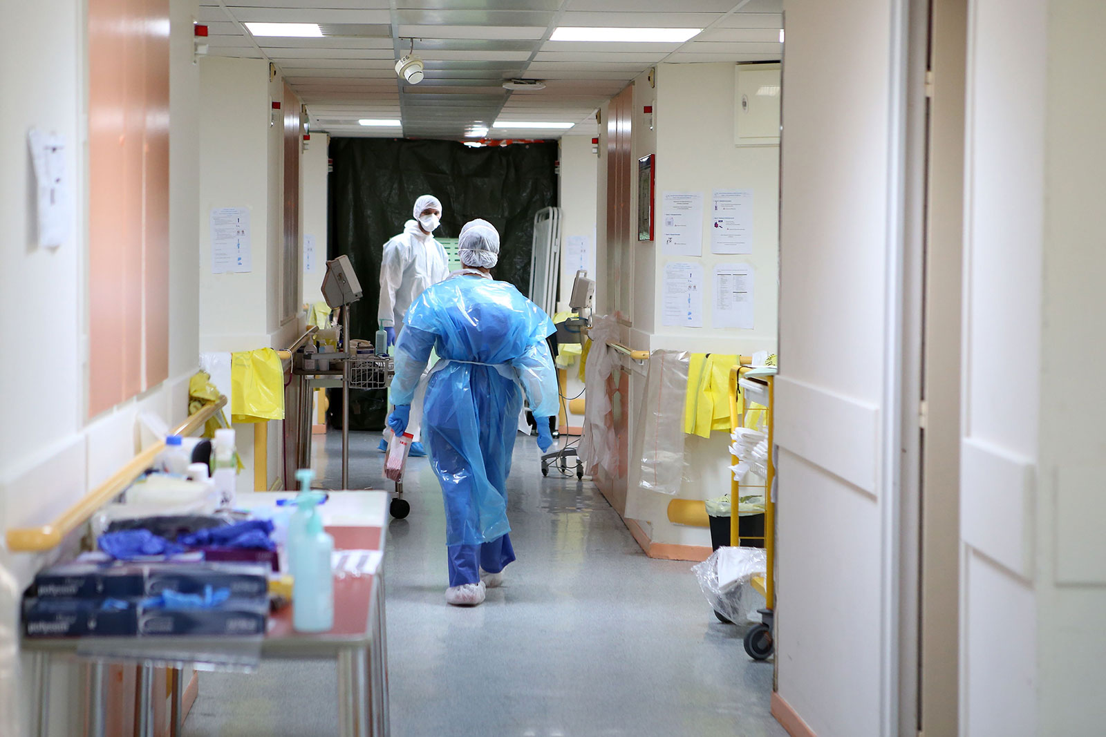 Nurses wearing protective gear walk in a hallway at a hospital in Ajaccio, France, on April 23.
