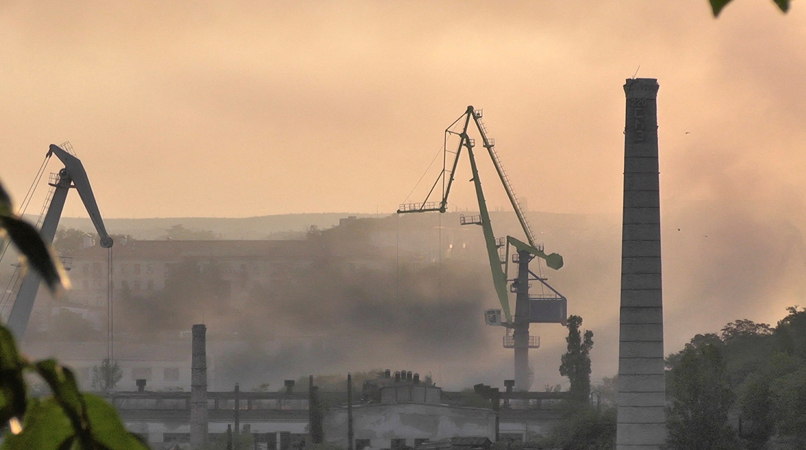 Smoke rises from the shipyard that was reportedly hit by Ukrainian missile attack in Sevastopol, Crimea, in this still image from video taken September 13.