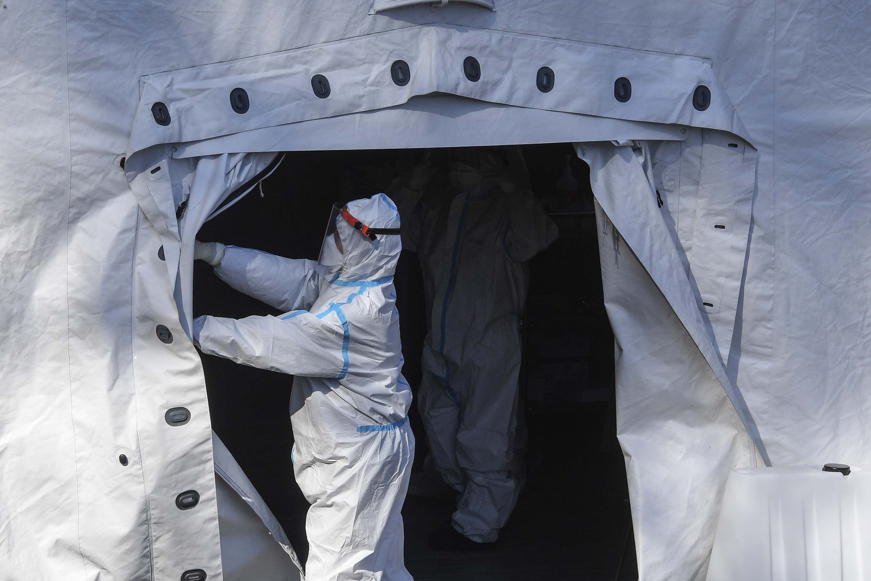 Doctors work at the pre-triage tent at the Cotugno hospital for infectious diseases in Naples, Italy, on March 23.