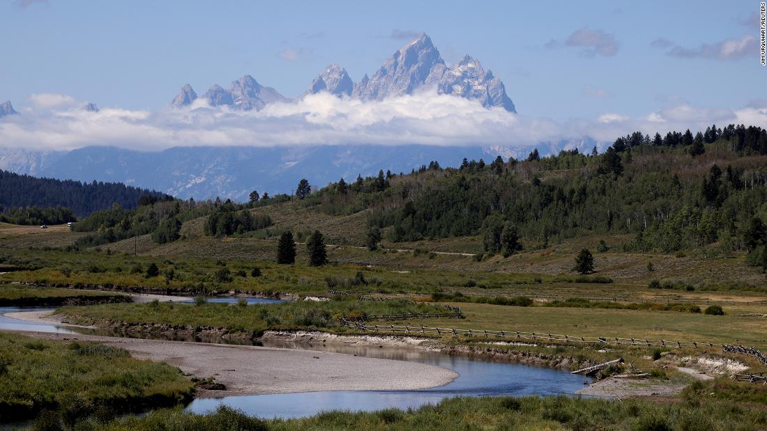 The Grand Tetons rise above the clouds in Grand Teton National Park where financial leaders from around the world are gathering for the Jackson Hole Economic Symposium, outside Jackson, Wyoming, on August 25.