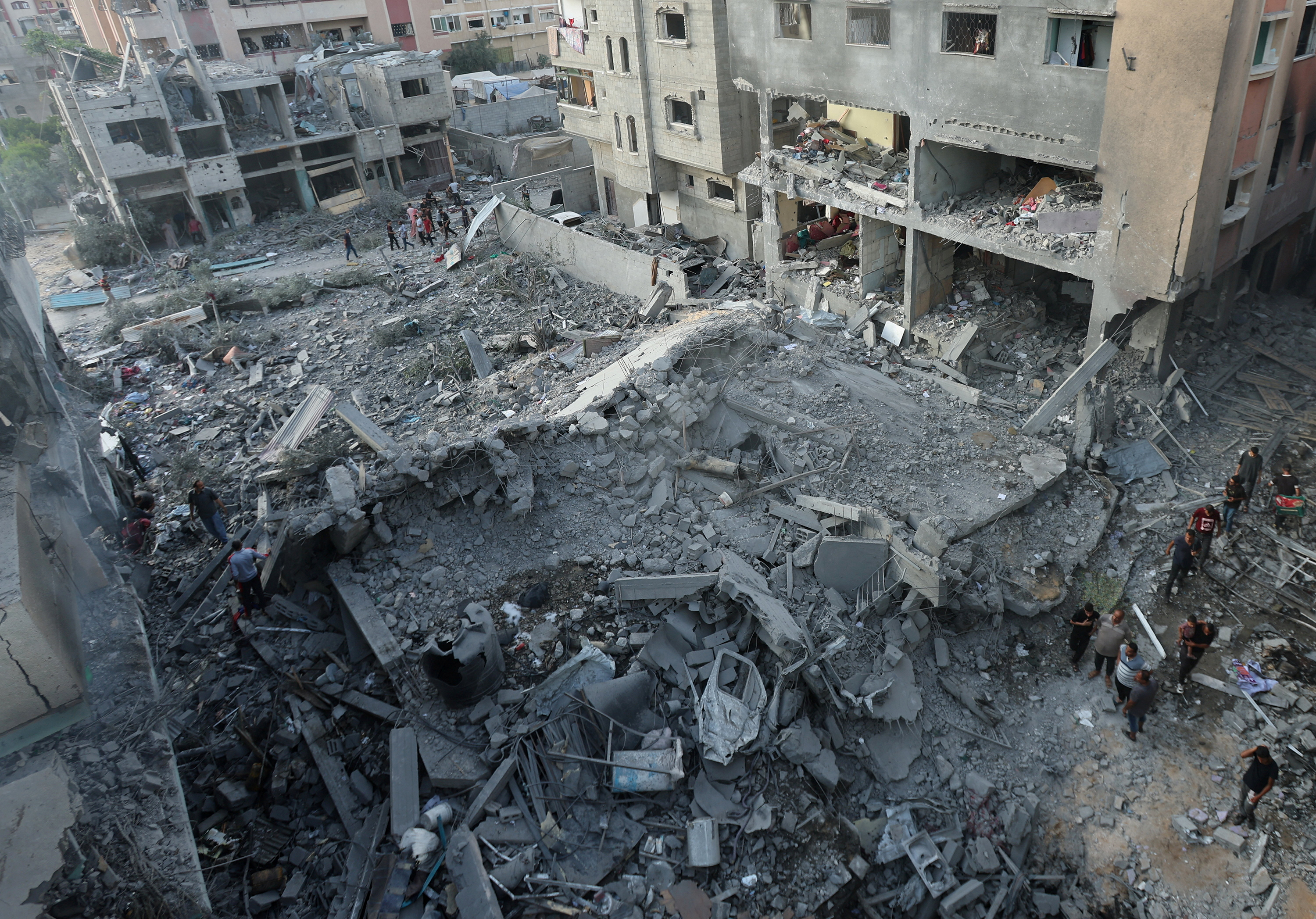 Palestinians inspect a house hit by an Israeli strike in Gaza’s Nuseirat refugee camp on June 8.