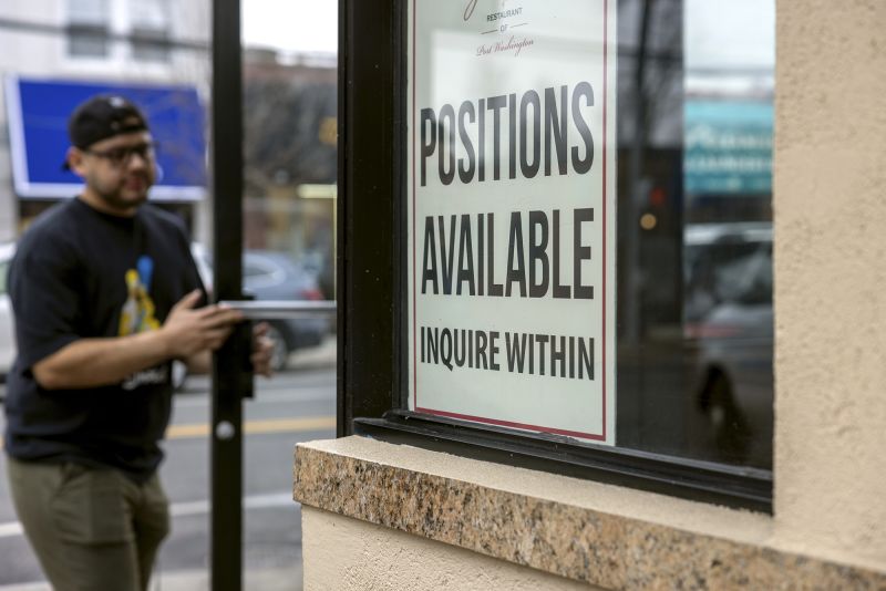 A Help Wanted sign seeking workers is on a restaurant window in Port Washington, New York, on January 5.