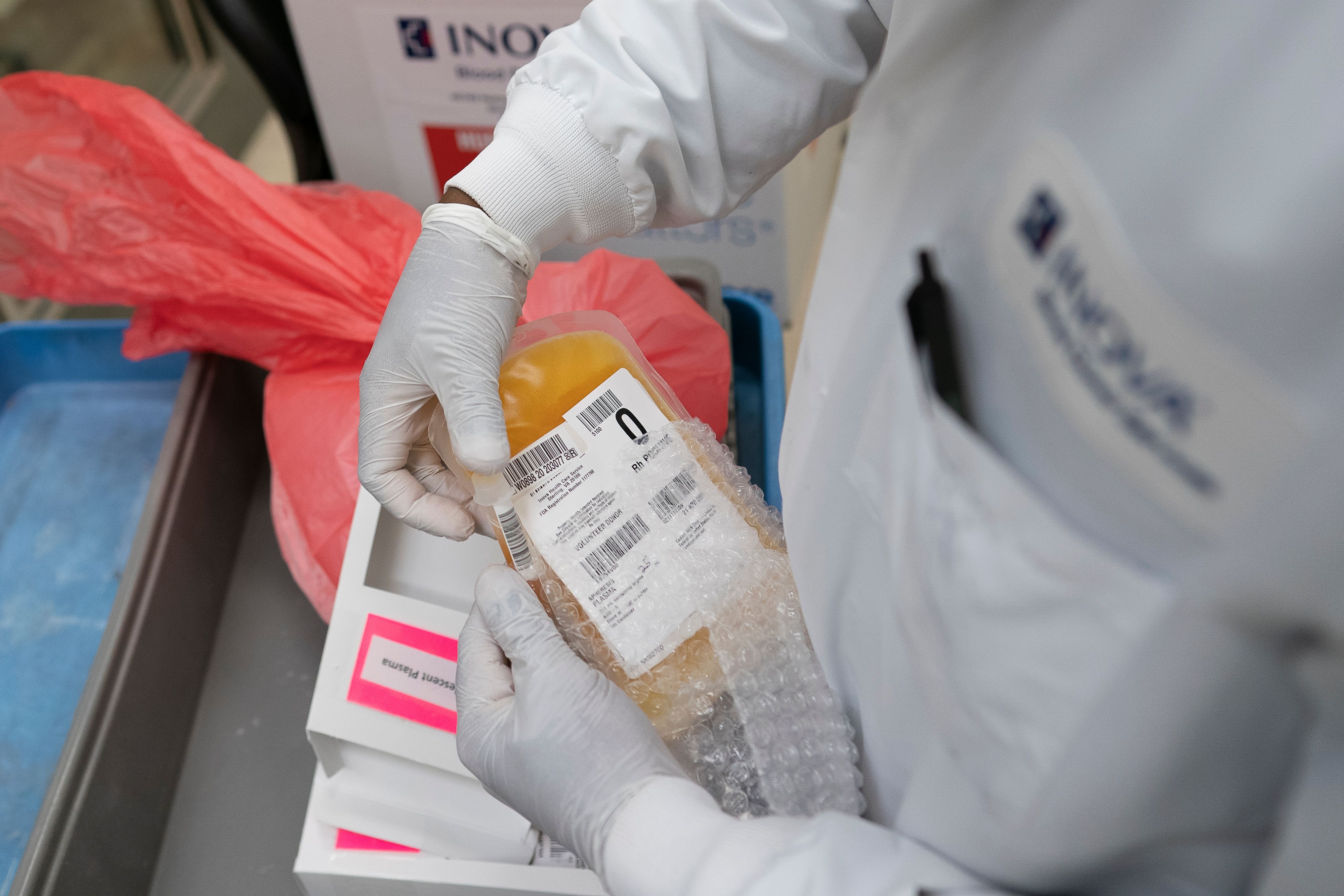 A lab technician packs donated convalescent plasma donated by recovered Covid-19 patients for shipping to local hospitals at Inova Blood Services on April 22 in Dulles, Virginia.