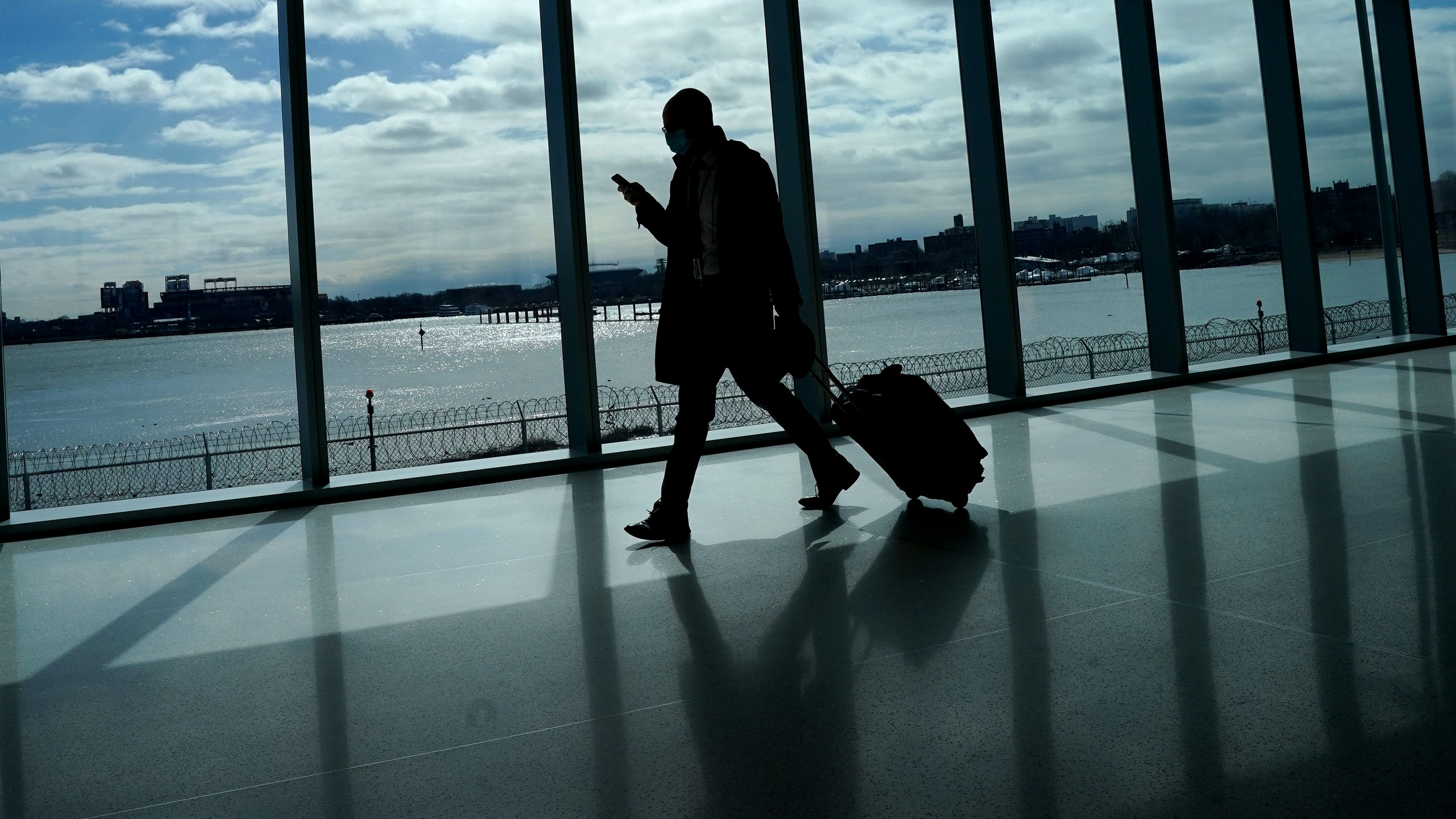 A traveler walks through LaGuardia Airport in New York, on March 6. 