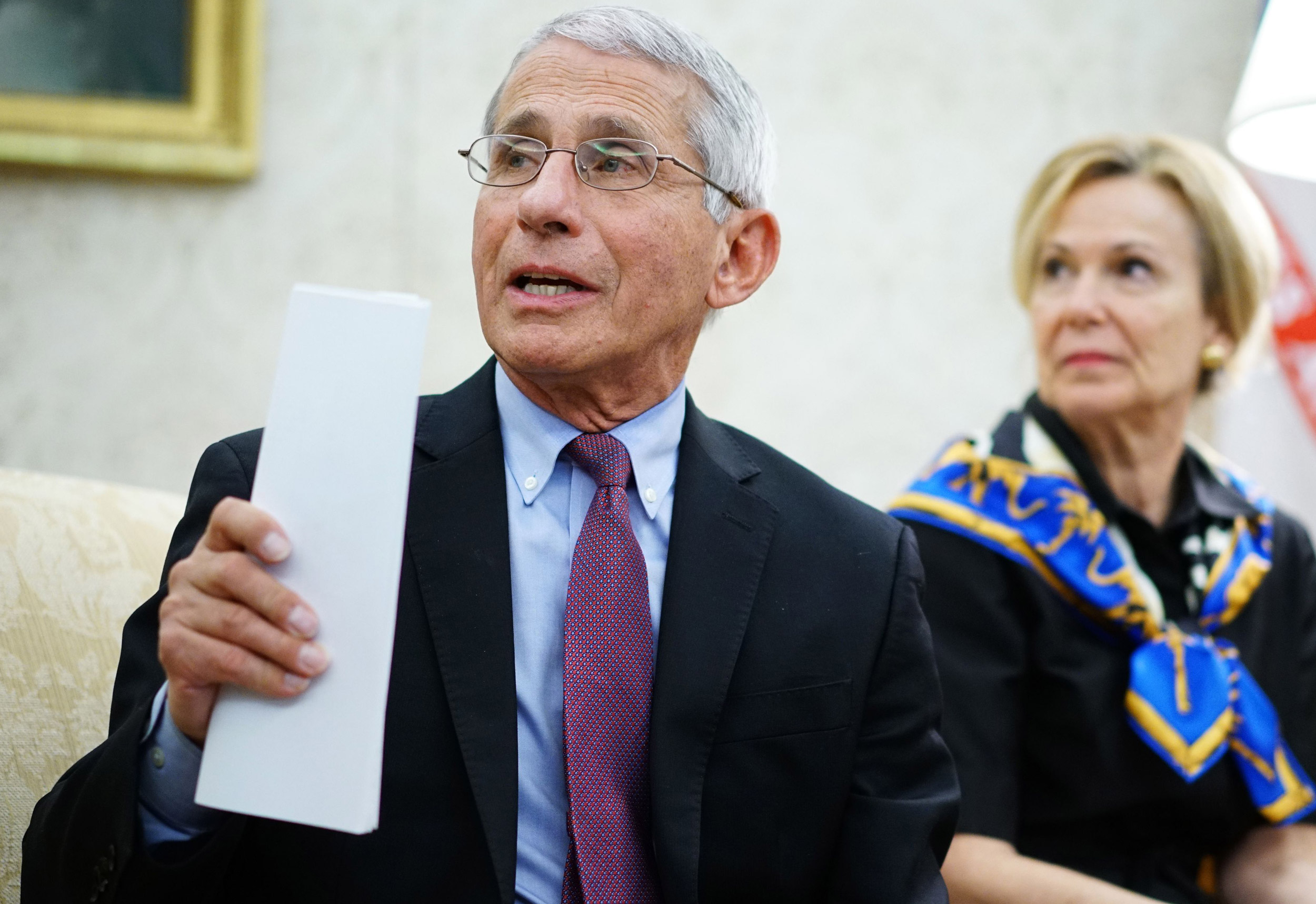Dr. Anthony Fauci, left, director of the National Institute of Allergy and Infectious Diseases speaks during a meeting in the Oval Office of the White House in Washington on April 29.