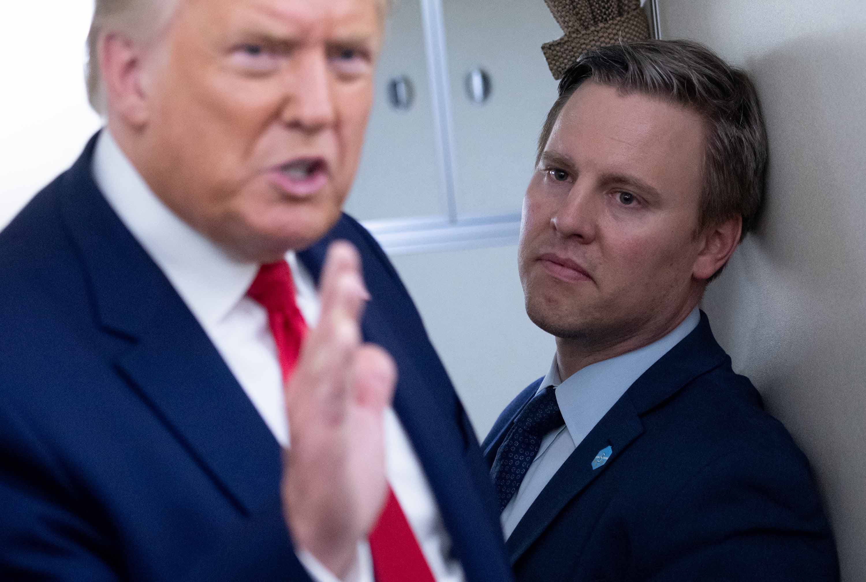 Campaign manager Bill Stepien is pictured alongside President Trump as he speaks with reporters aboard Air Force One on August 28.