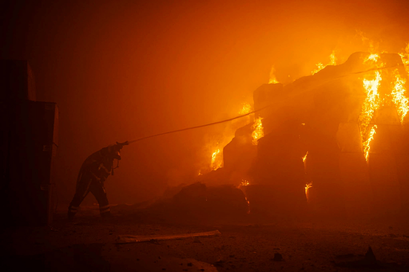 A firefighter works at a site of a tobacco factory damaged by a Russian drone strike in Kyiv, Ukraine, on May 28. 