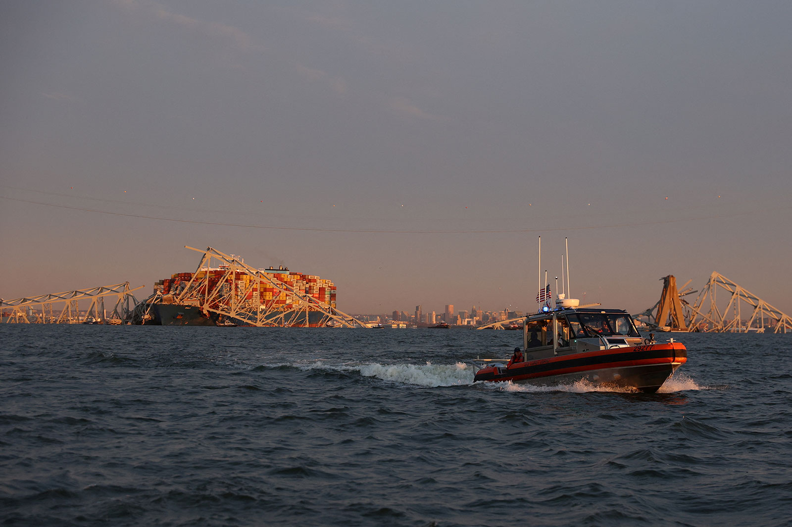 A US Coast Guard vessel secures the perimeter following the collapse of the Francis Scott Key Bridge in Baltimore on Tuesday. 