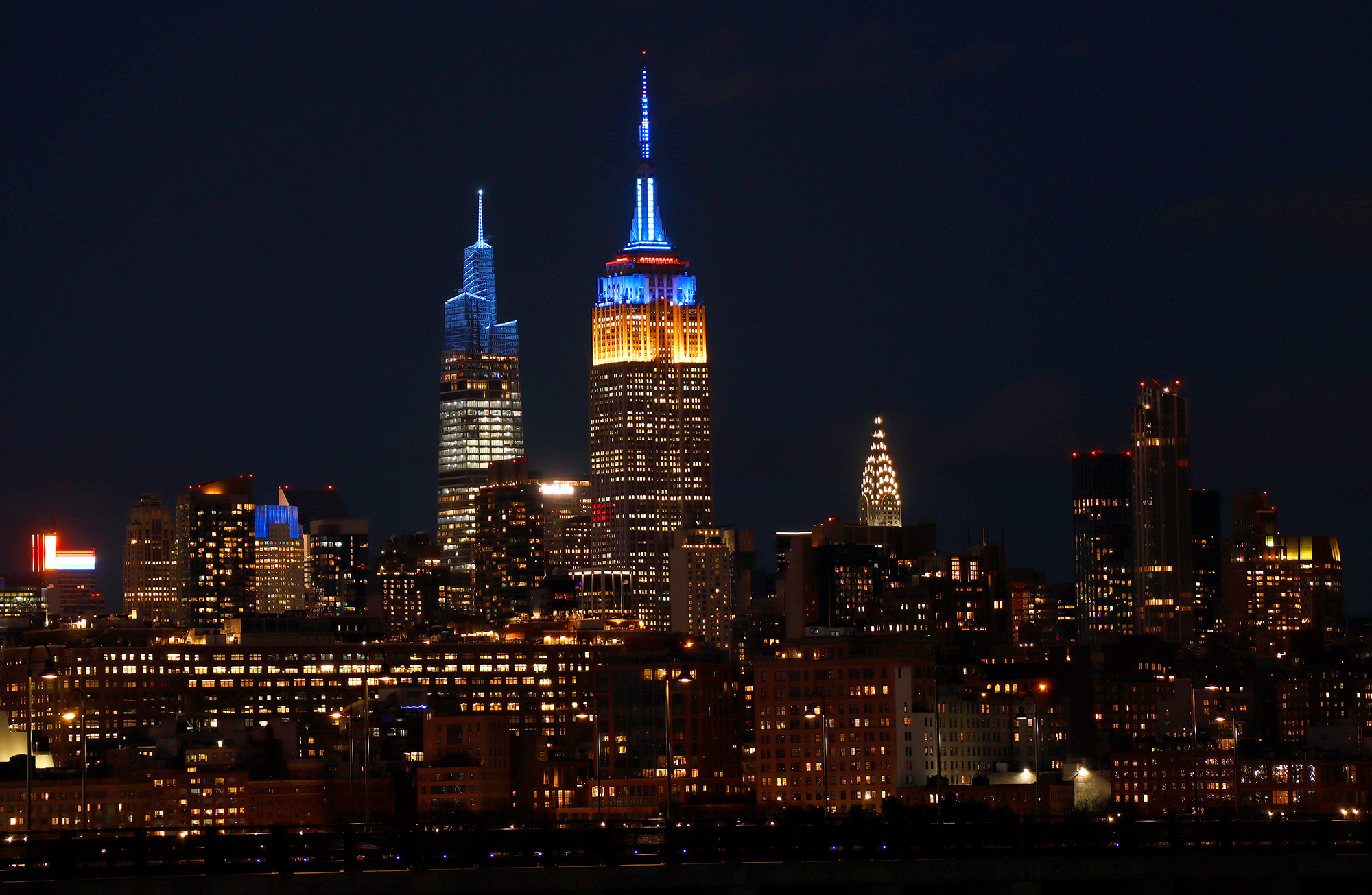 Landmarks around the world glow blue and yellow in support of Ukraine