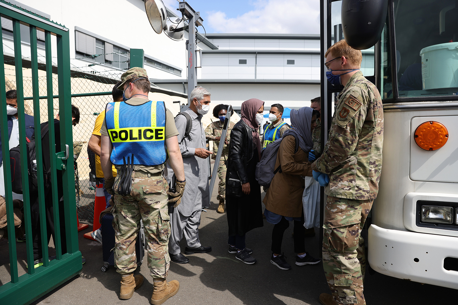 Evacuees from Afghanistan walk from a temporary tent to a bus at Ramstein Air Base on August 26, 2021 in Ramstein-Miesenbach, Germany. 