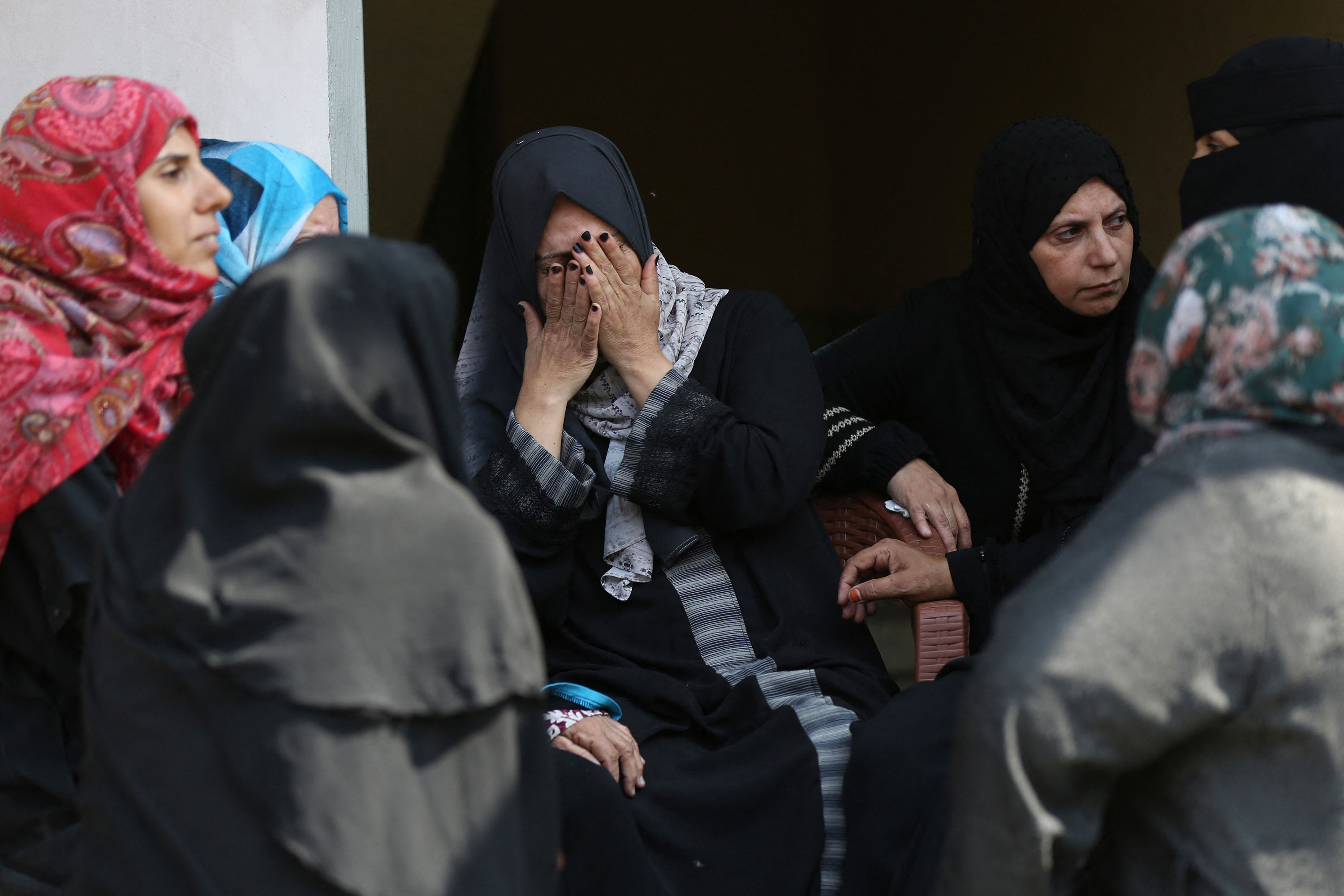 People mourn family members killed in Israeli strikes during a funeral in Khan Yunis, Gaza, on Sunday, October 8. 