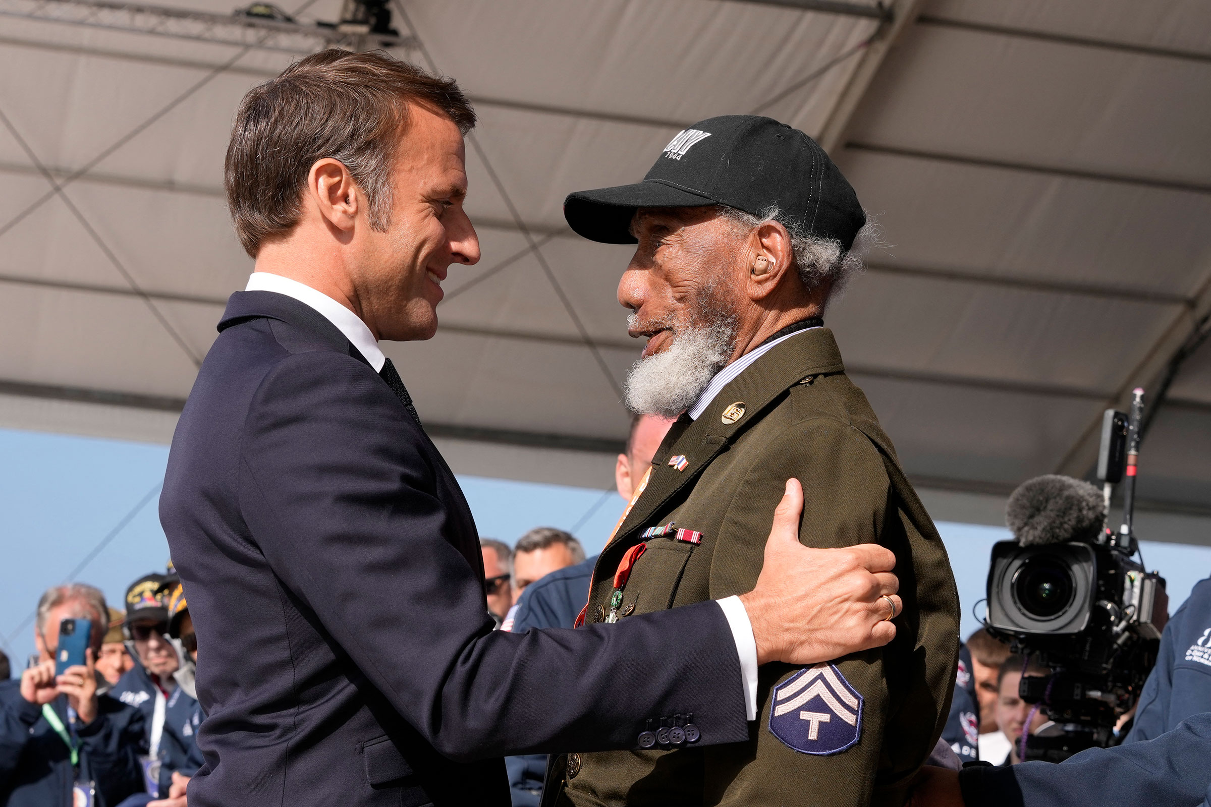 French President Emmanuel Macron awards US WWII veteran Arlester Brown with the Legion of Honor during the International commemorative ceremony at Omaha Beach marking the 80th anniversary of the World War II "D-Day" Allied landings in Normandy, in Saint-Laurent-sur-Mer, in northwestern France, on June 6.