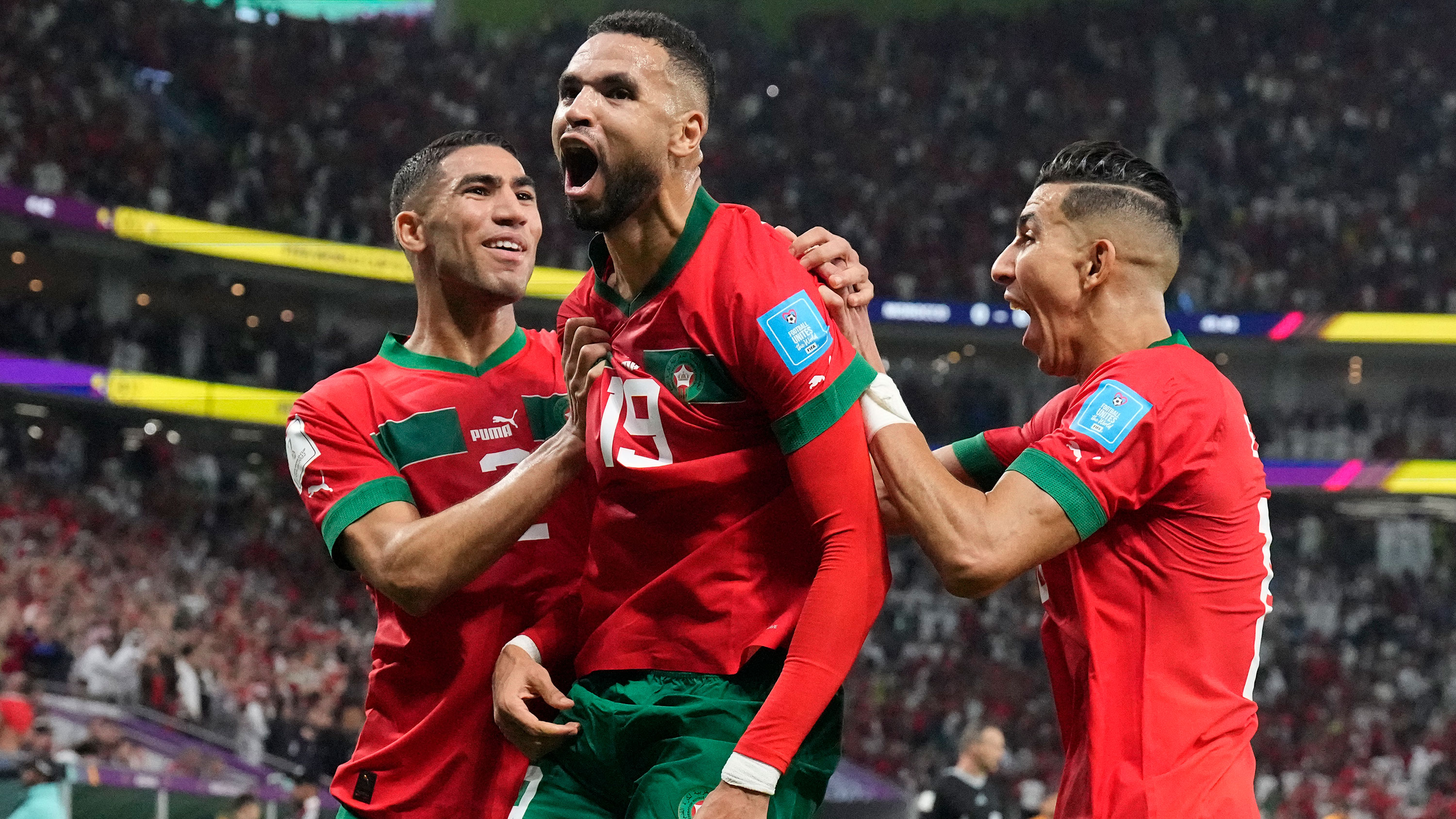 Morocco's Youssef En-Nesyri, center, celebrates after scoring his a goal against Portugal on Saturday.