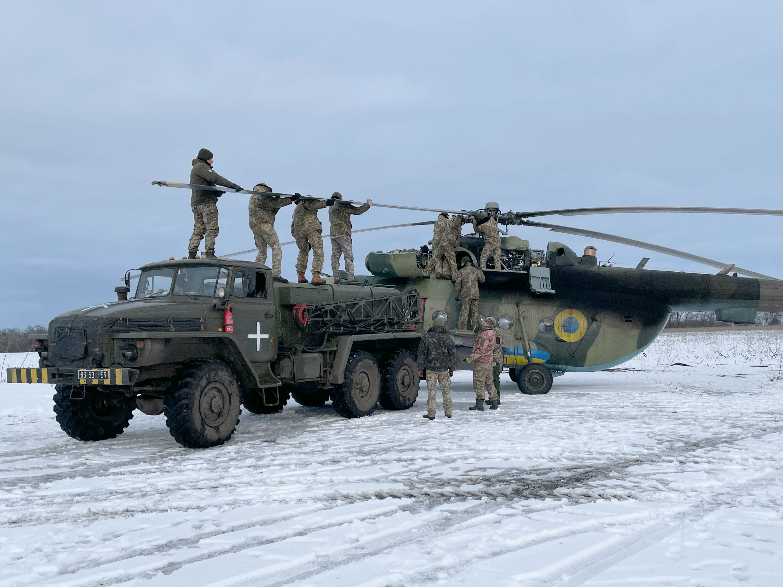 After striking a tree, engineers work to replace the blades on the Soviet-built Mi-8 helicopter. 