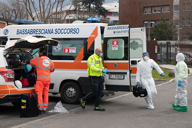 Medical staff get ready to receive a Covid-19 patient arriving by helicopter at the Spedali Civili Hospital, in Brescia, Italy, Friday, March 27. 