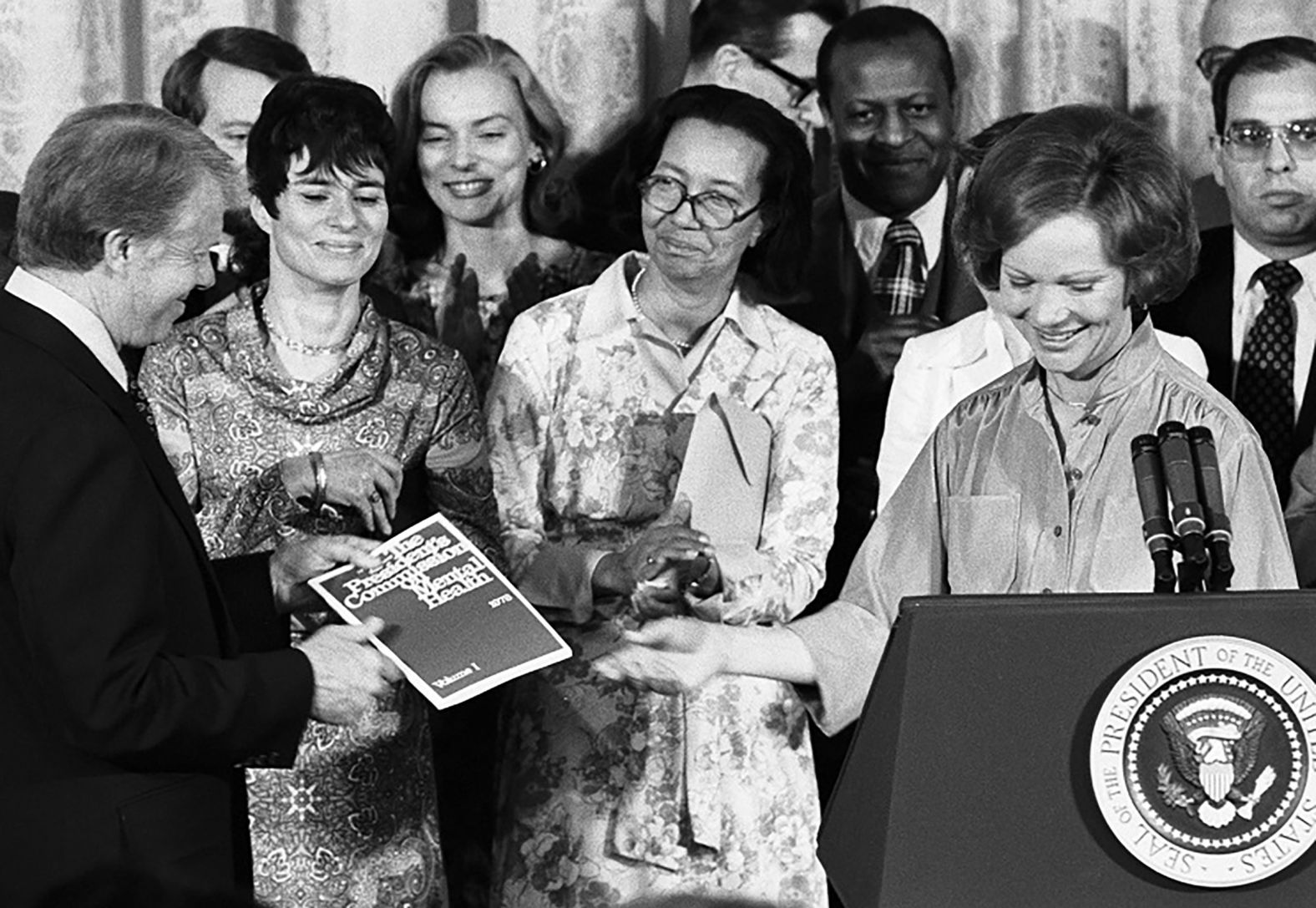 As honorary chairwoman of the President's Commission on Mental Health, Rosalynn presents her husband with the commission's recommendations for sweeping reforms to mental health policy and programs in 1978. The report led to the Mental Health Systems Act of 1980. Rosalynn has been a driving force for mental health throughout her life.