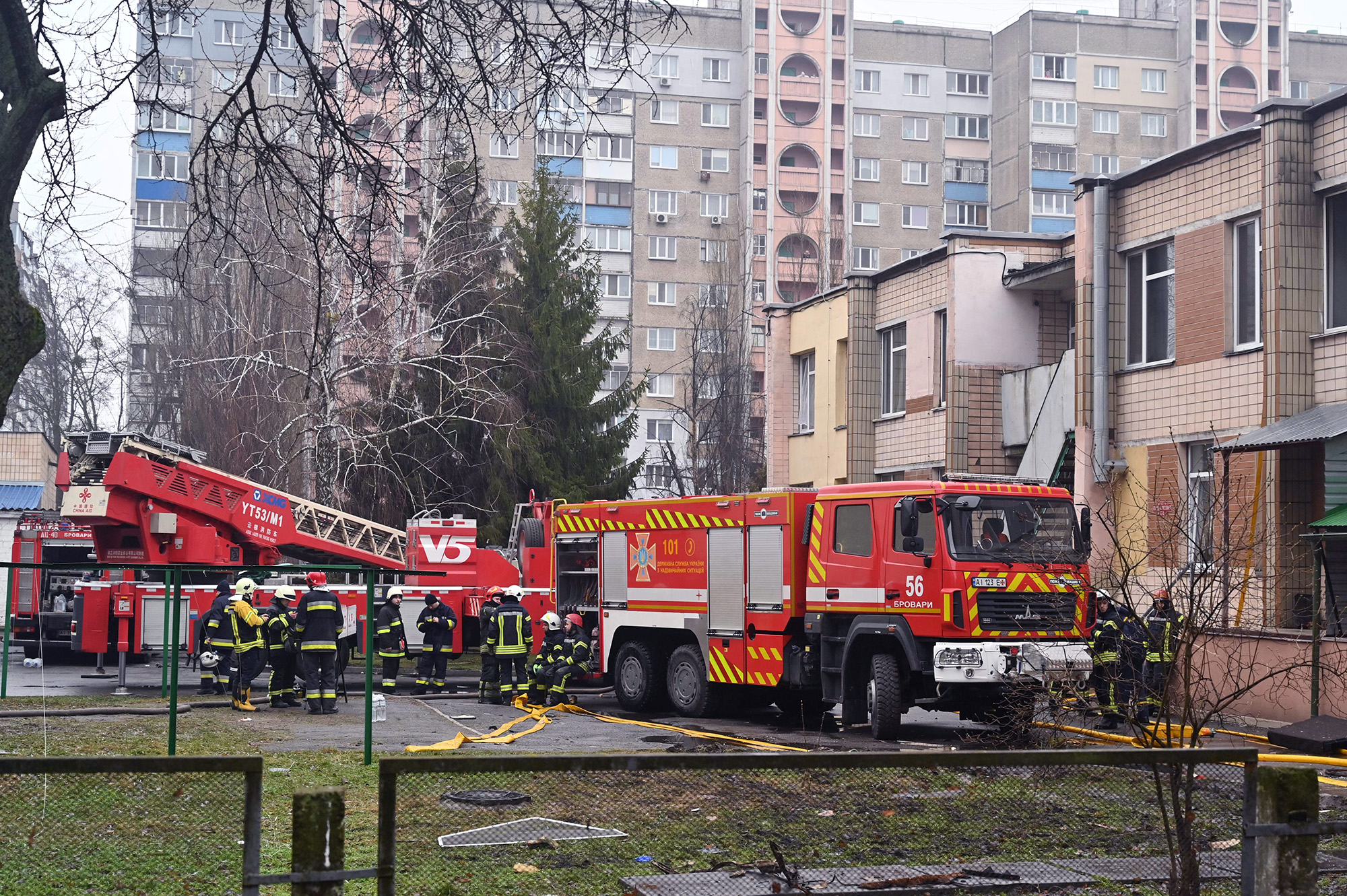 Firefighters work near the site where a helicopter crashed near a kindergarten in Brovary, Ukraine, on January 18.