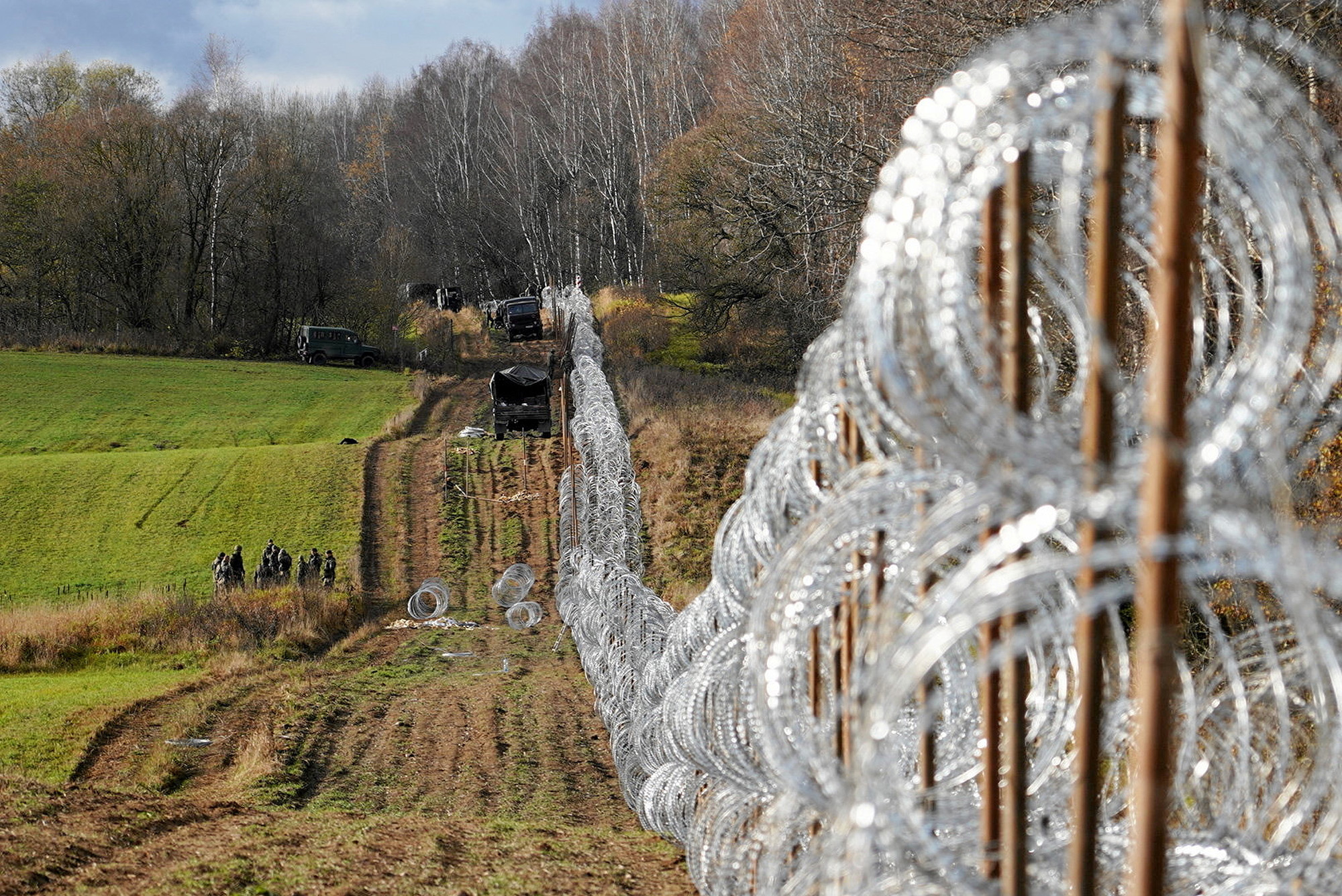 Soldiers build a razor wire fence on Poland's border with Kaliningrad near Bolcie, Poland, on November 3.